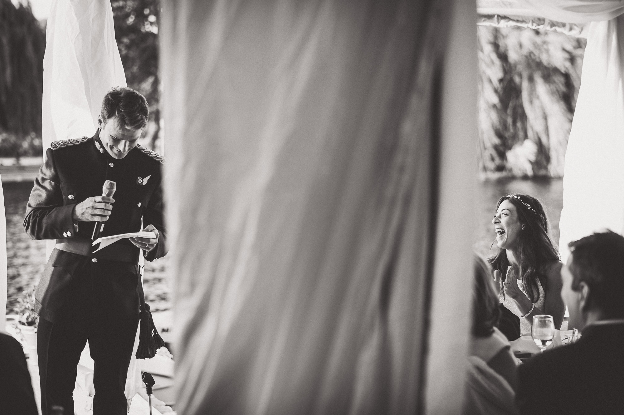 A man is delivering a heartwarming speech at a wedding.