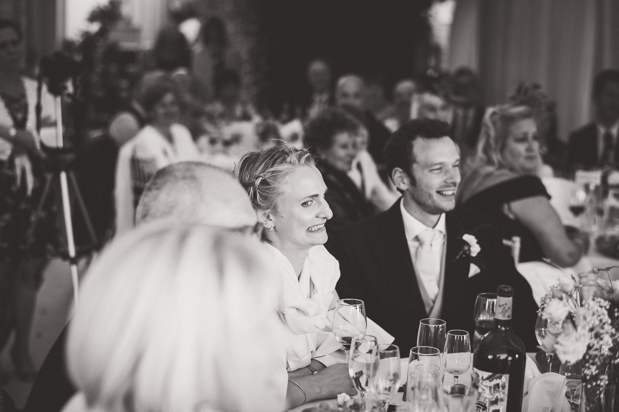 A wedding photo of a bride and groom at a table.