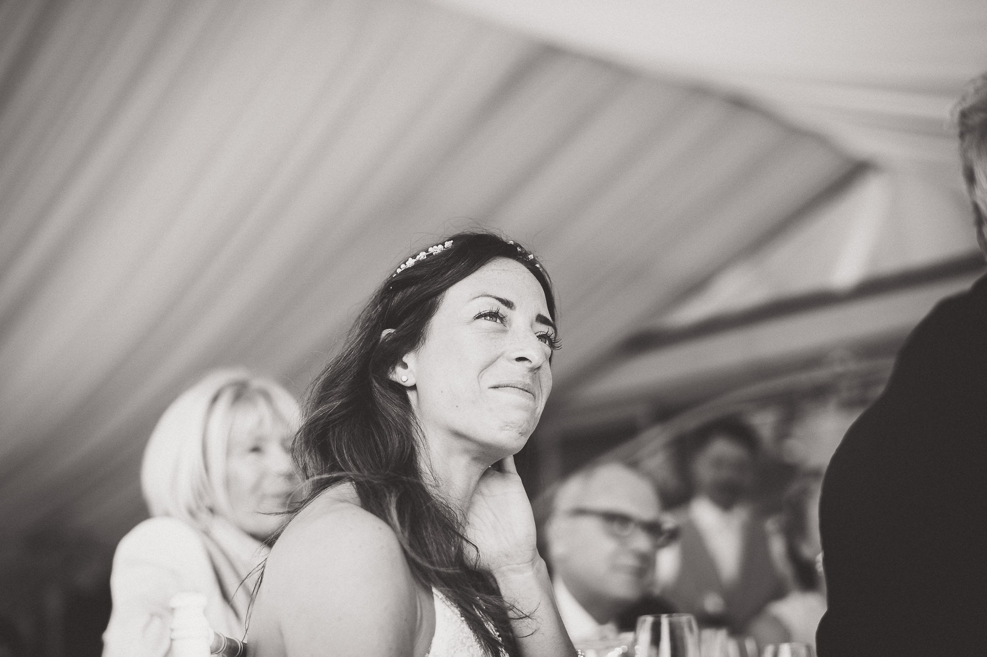 A bride joyfully delivers her wedding speech.