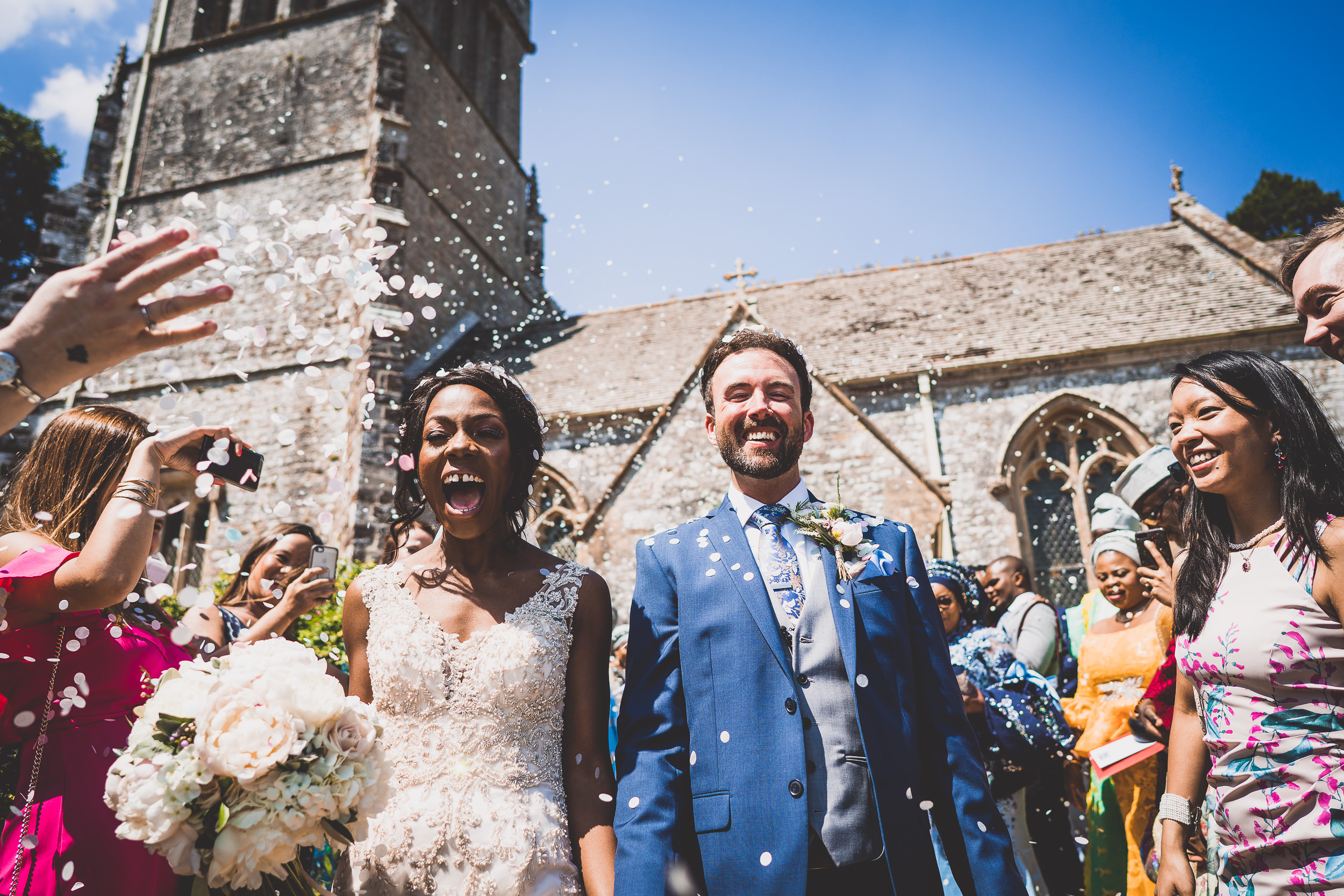 A wedding photographer captures a bride and groom amidst confetti on their special day.