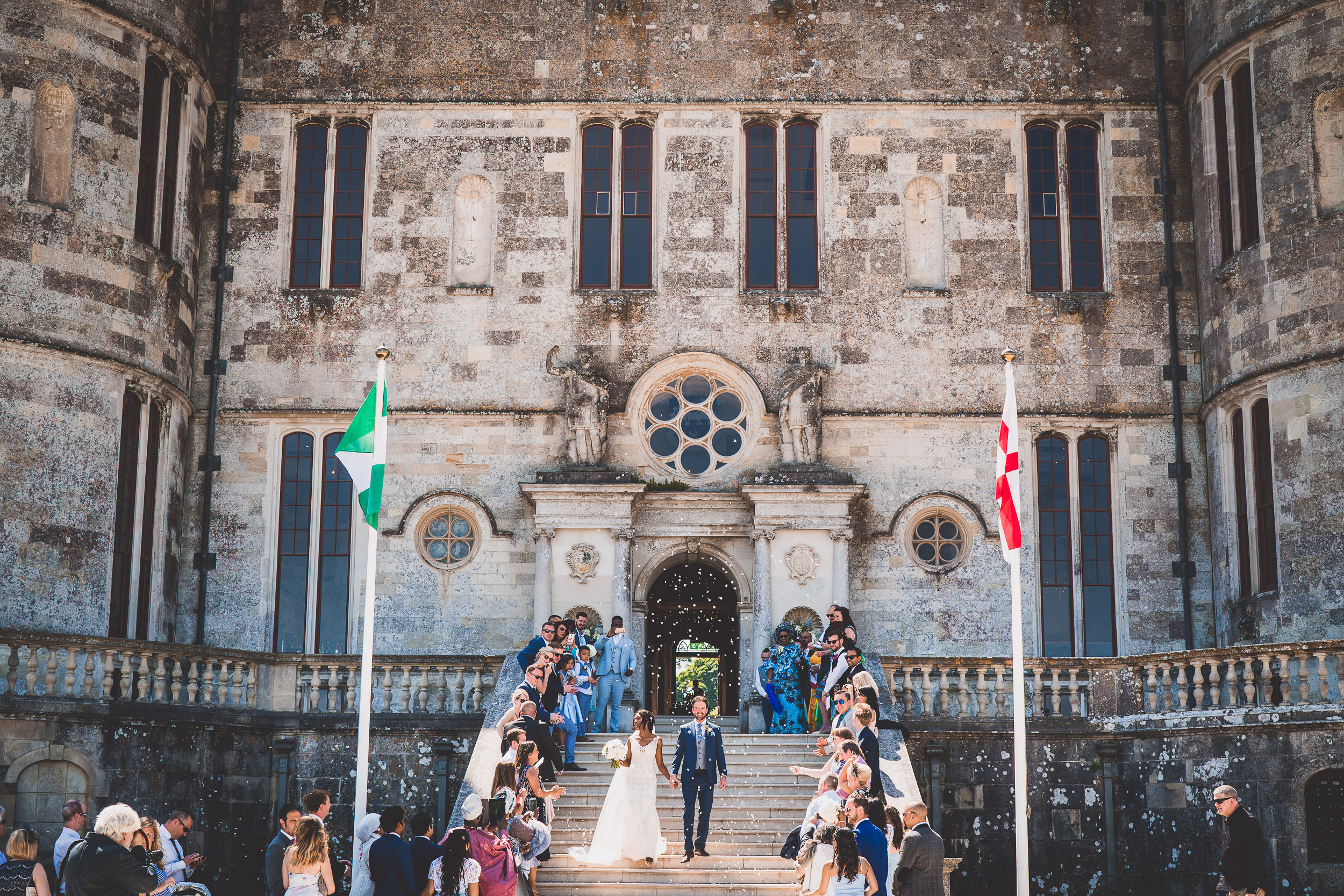 A wedding couple descending castle steps.