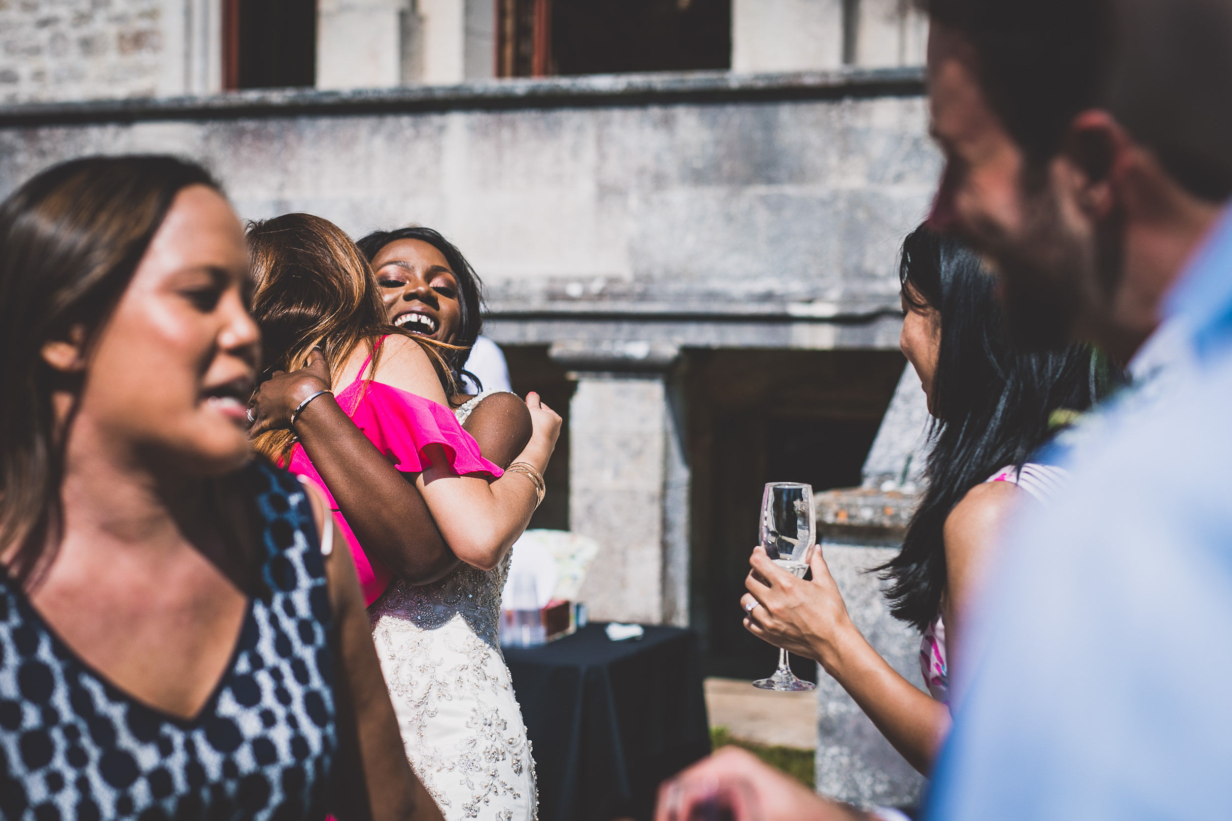 A wedding photographer captures a joyful group, including the groom, laughing in a wedding photo.