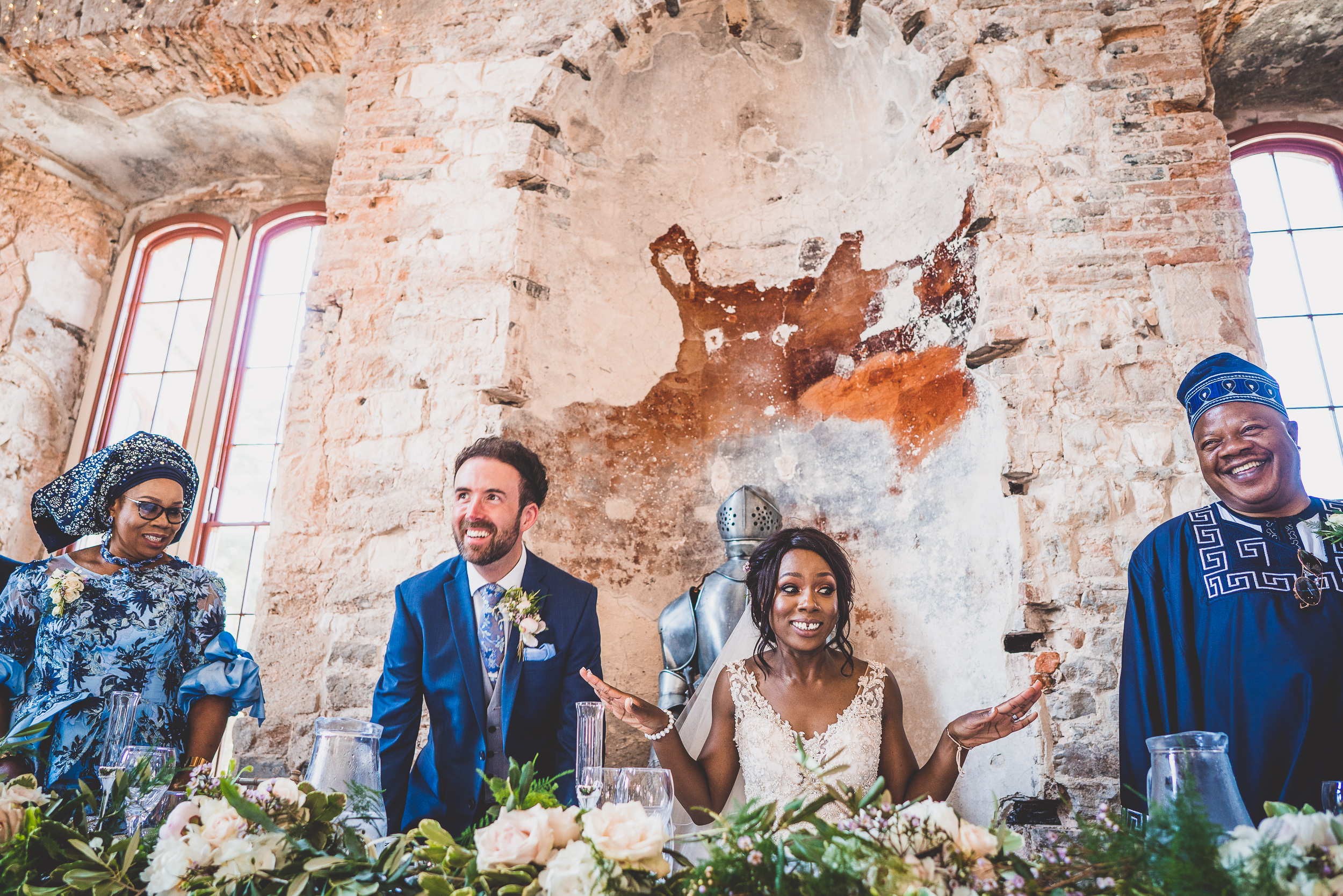 A bride and groom in a wedding photo at a castle.