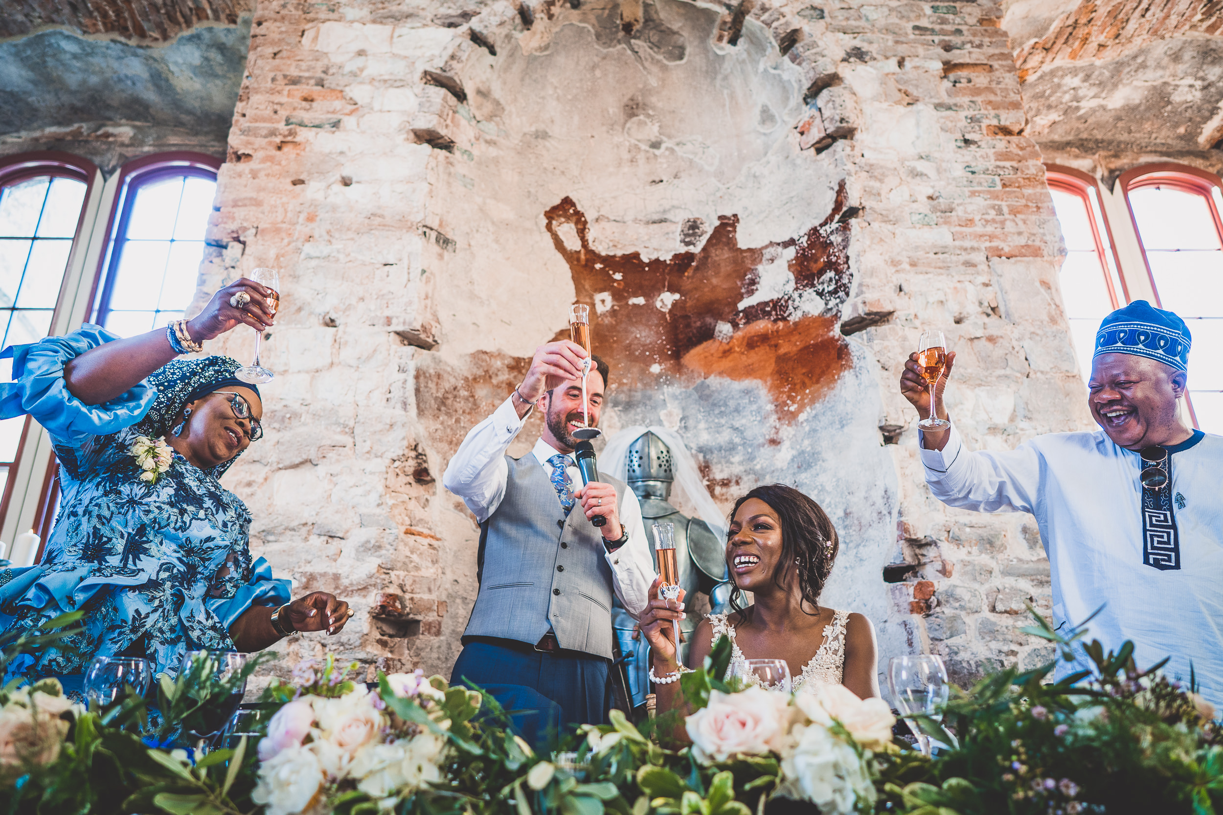 A bride and her wedding party pose for a memorable wedding photo in a church.