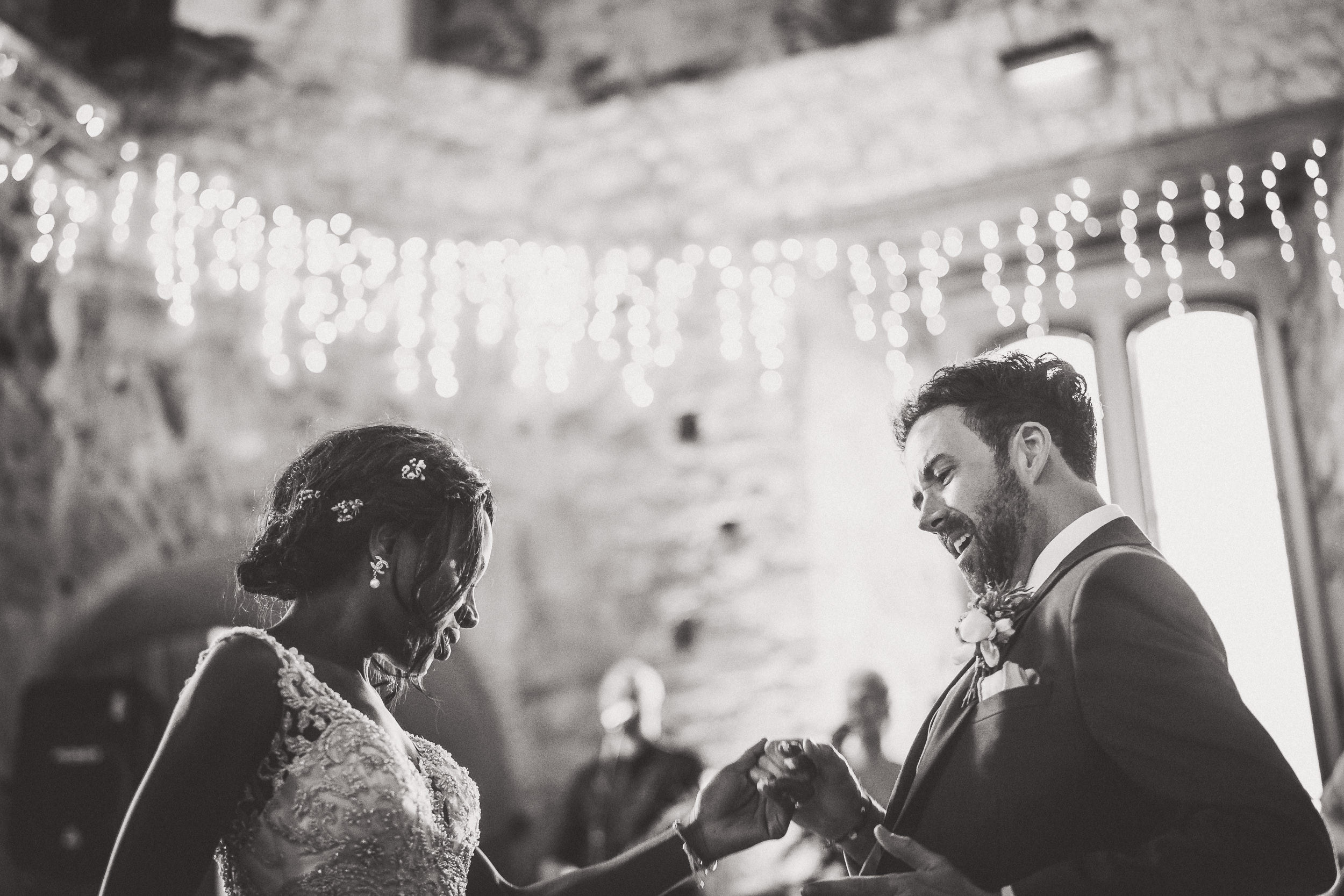 A groom and bride captured in a wedding photo during their first dance in a castle.