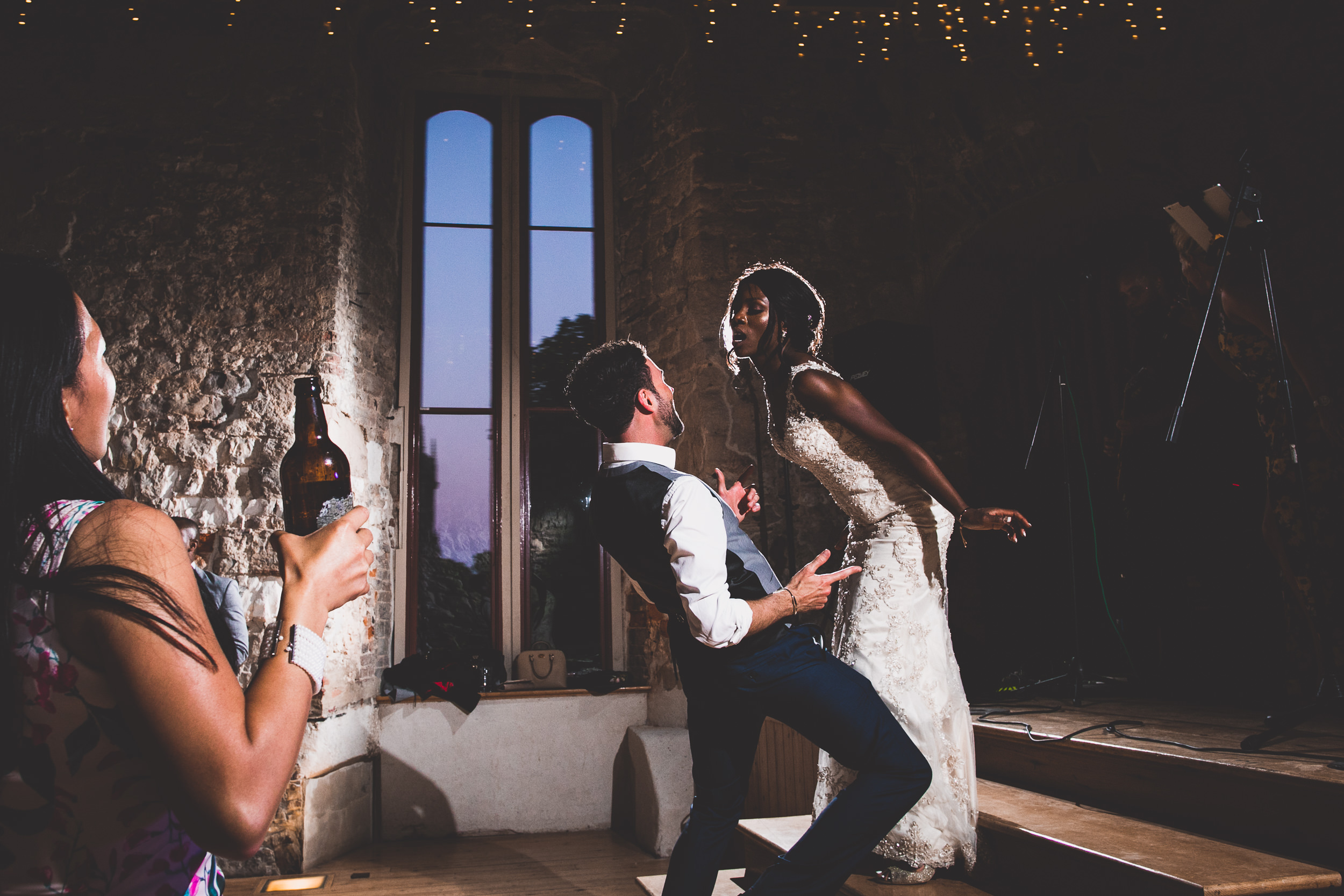 A wedding photo featuring a bride and groom dancing in a castle.