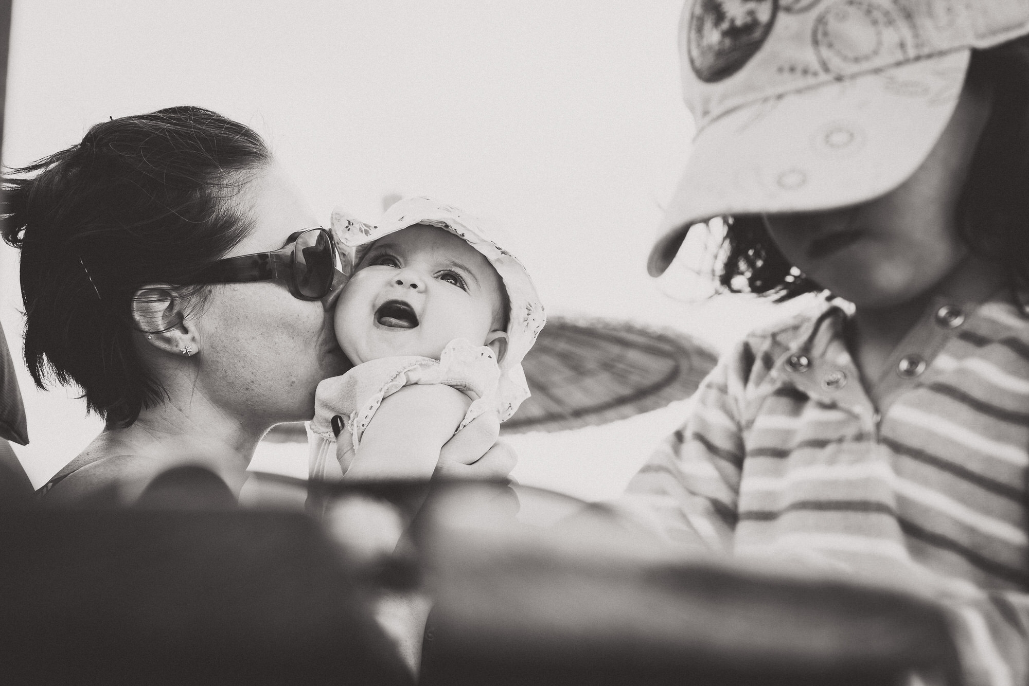 A bride kissing a baby.