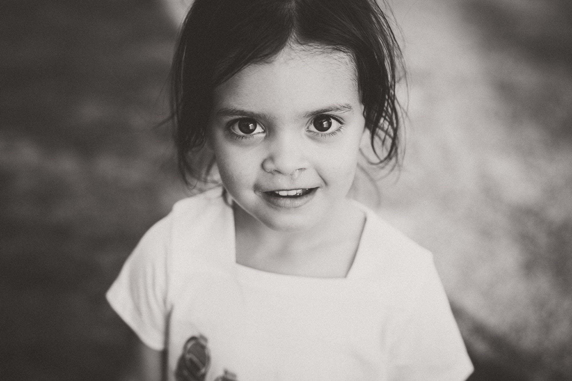 A black and white wedding photo featuring a little girl.