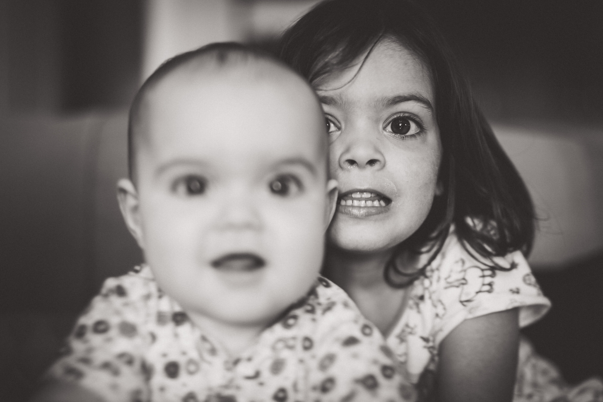 A black and white wedding photo capturing two children looking at each other.