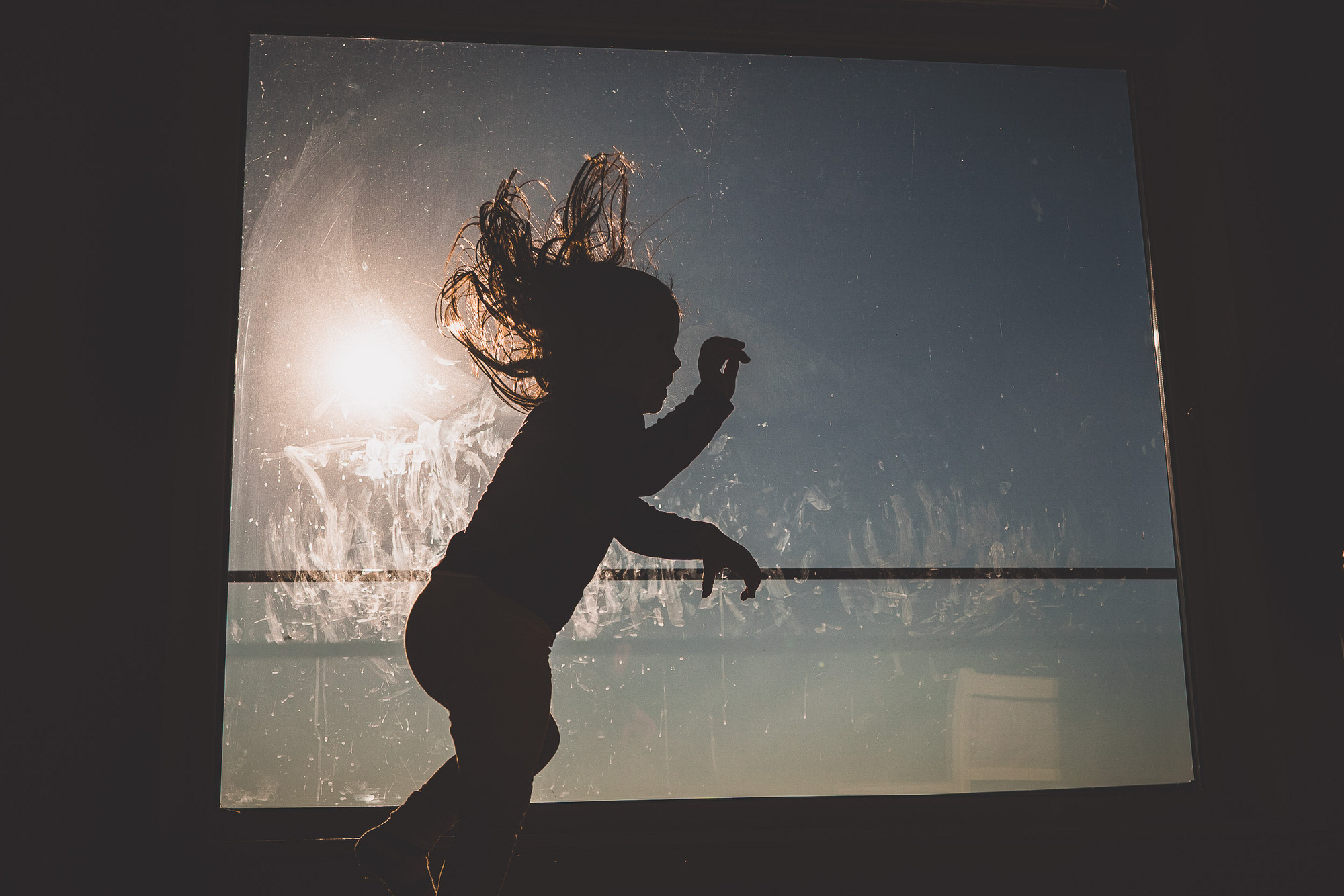 A bride's wedding photo captures a little girl jumping out of a window.