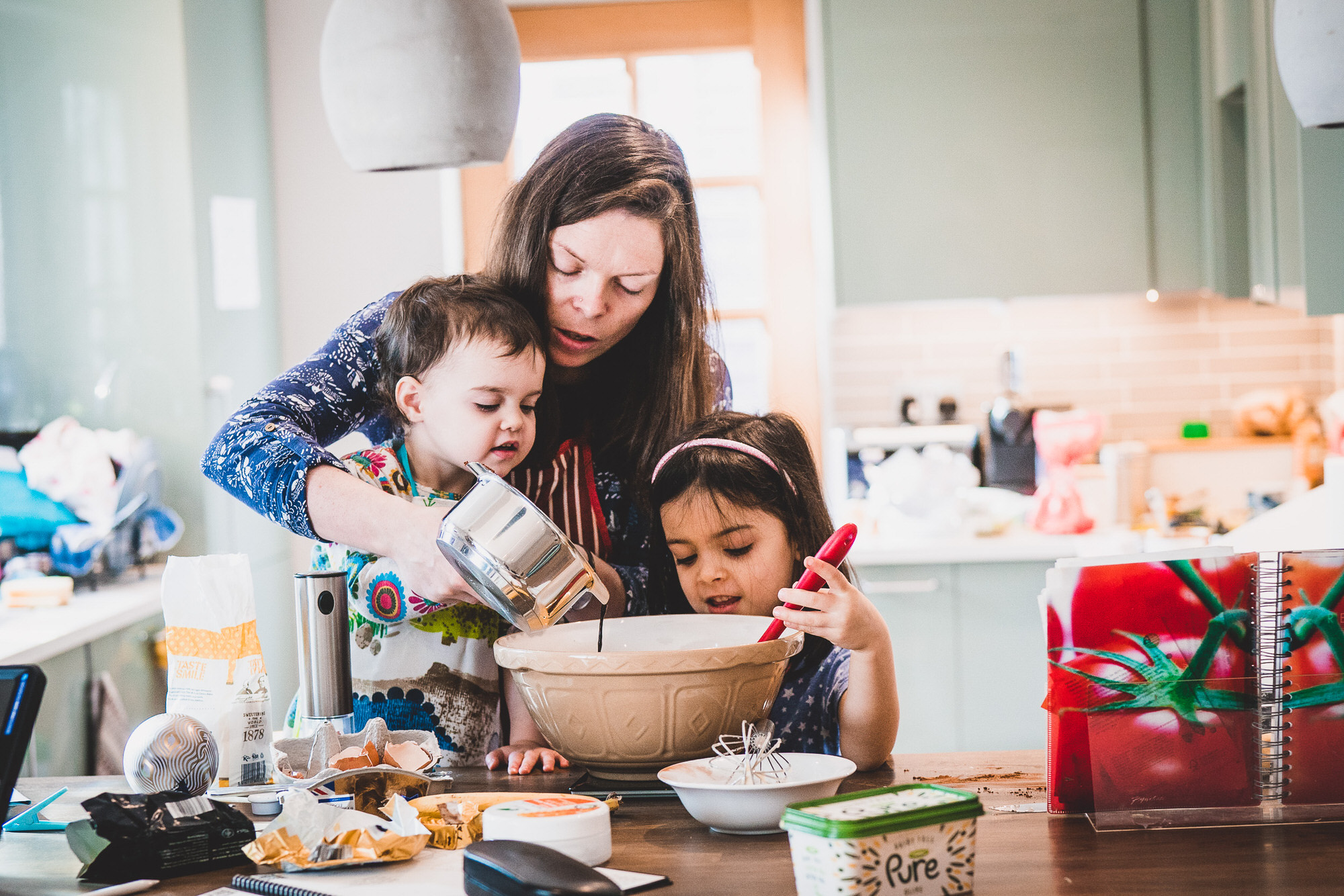 A bride and groom are making cookies in the kitchen.