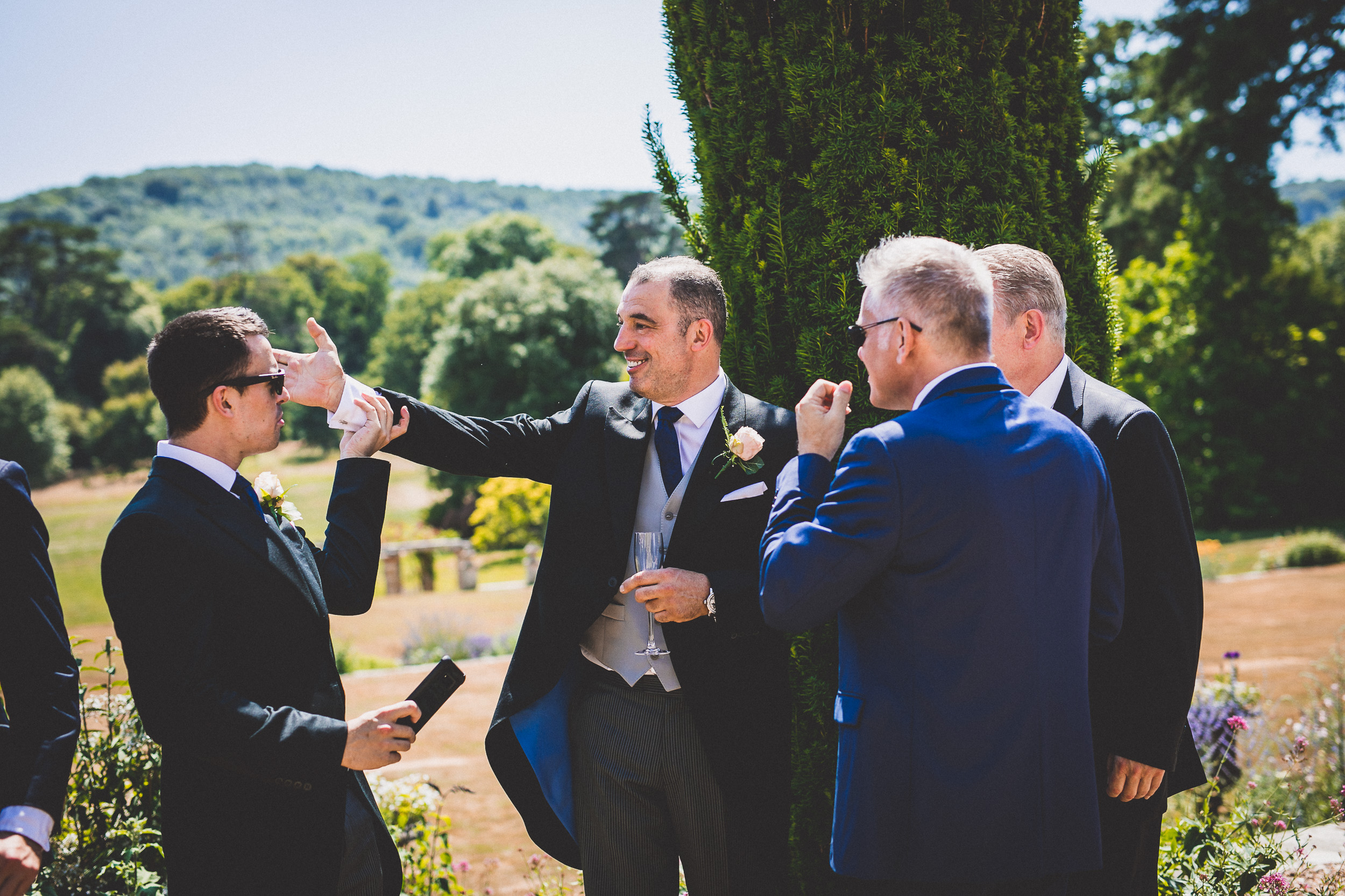 A group of groomsmen posing for a wedding photo.