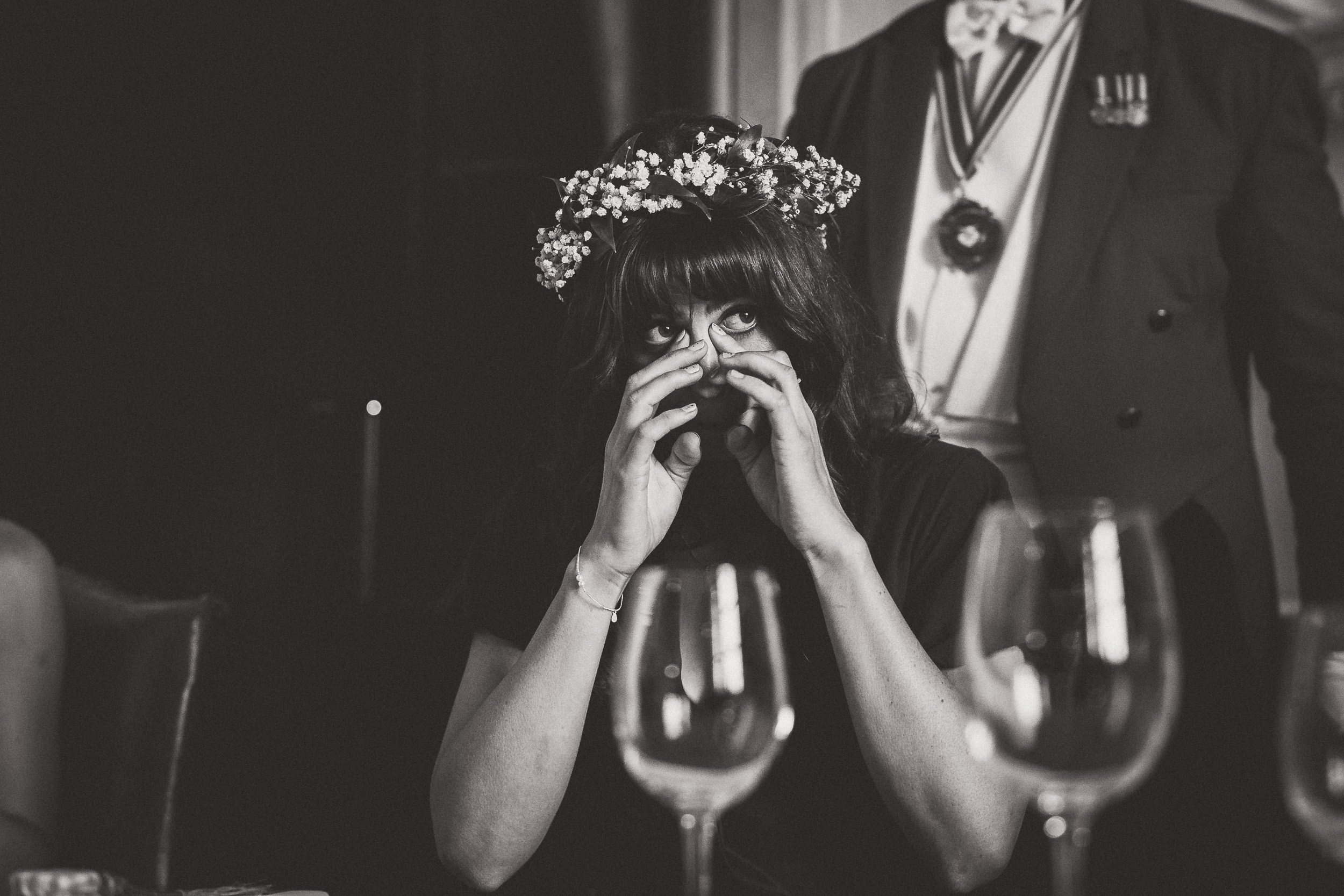 A bride is sitting at a table with a wedding photographer.