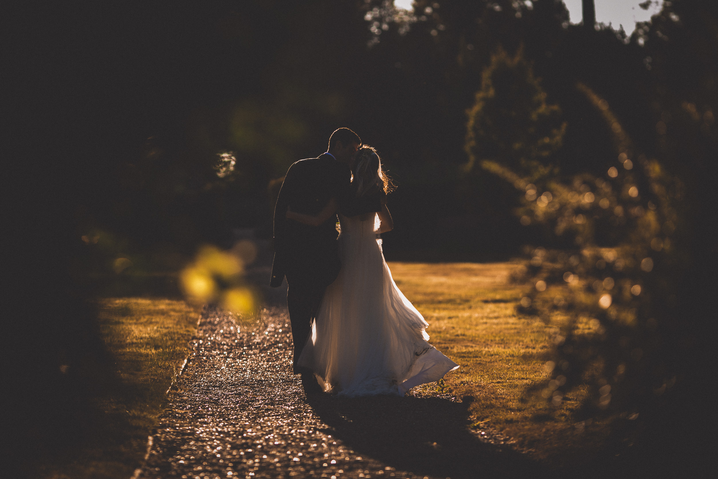 A groom captured in a breathtaking wedding photo at sunset.