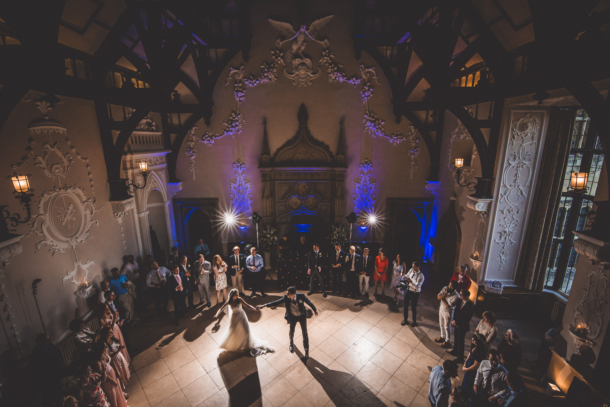 A bride and groom captured by a wedding photographer in an ornate room.