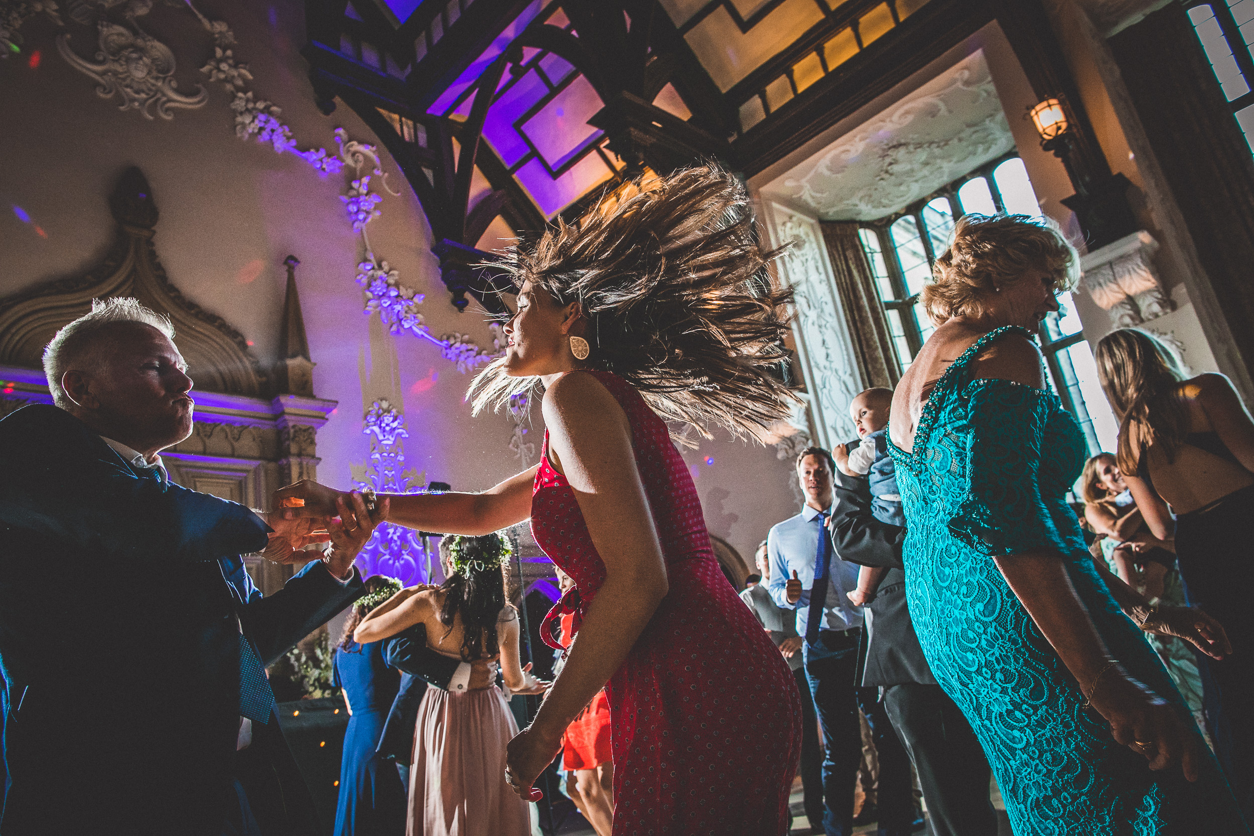 A group of people dancing at a wedding.