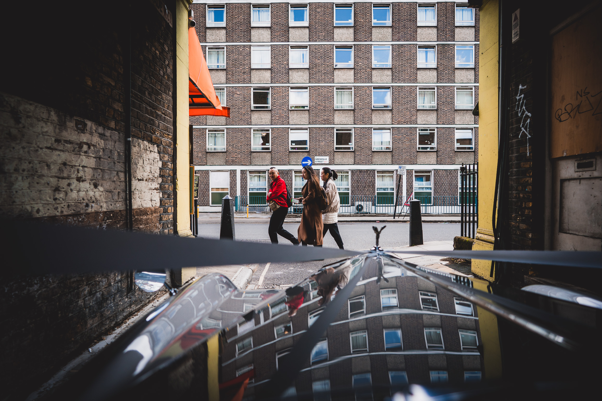 A bride and groom strolling down a city street, capturing their special moment in a wedding photo.