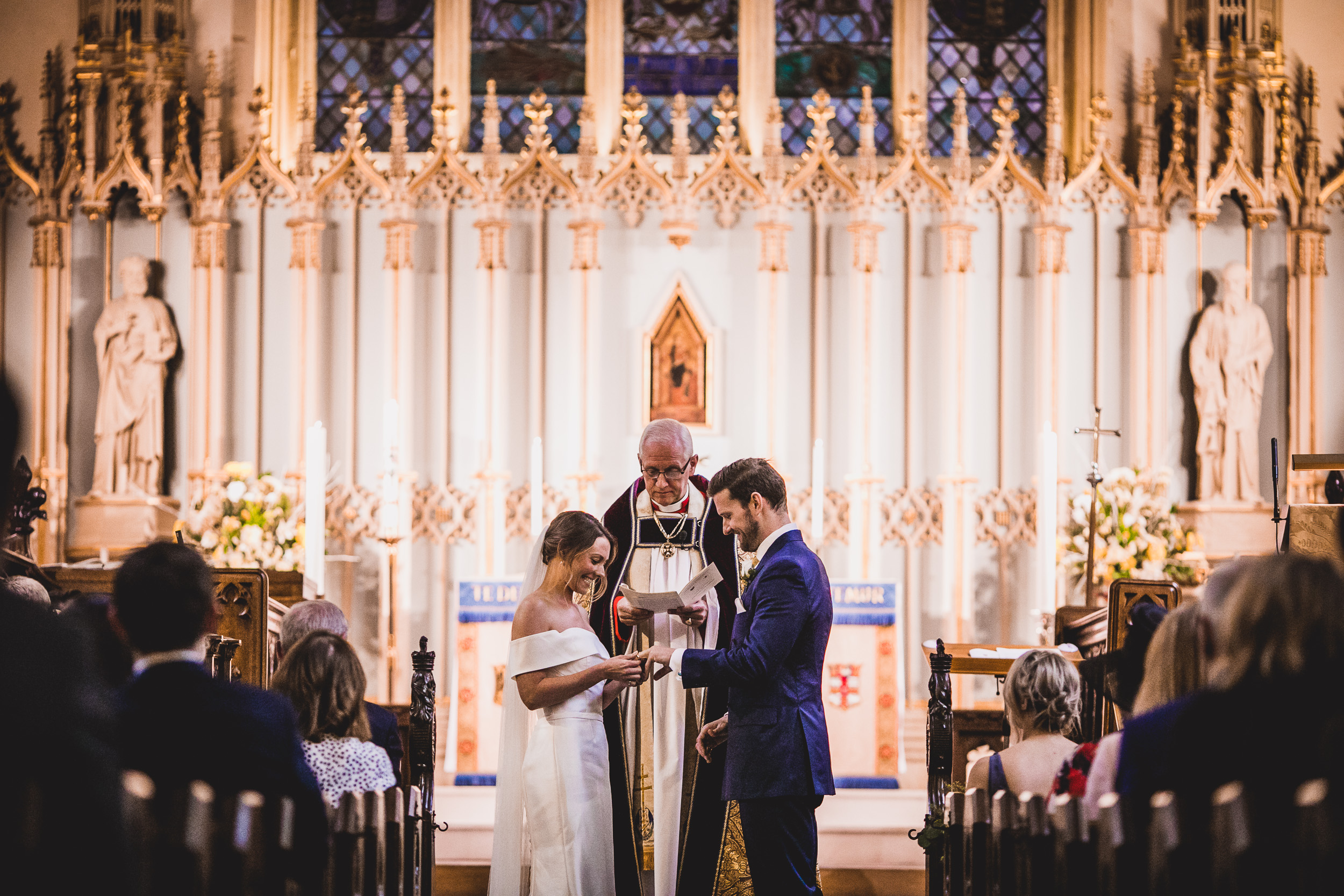 A bride and groom exchange their vows in a church at their wedding.