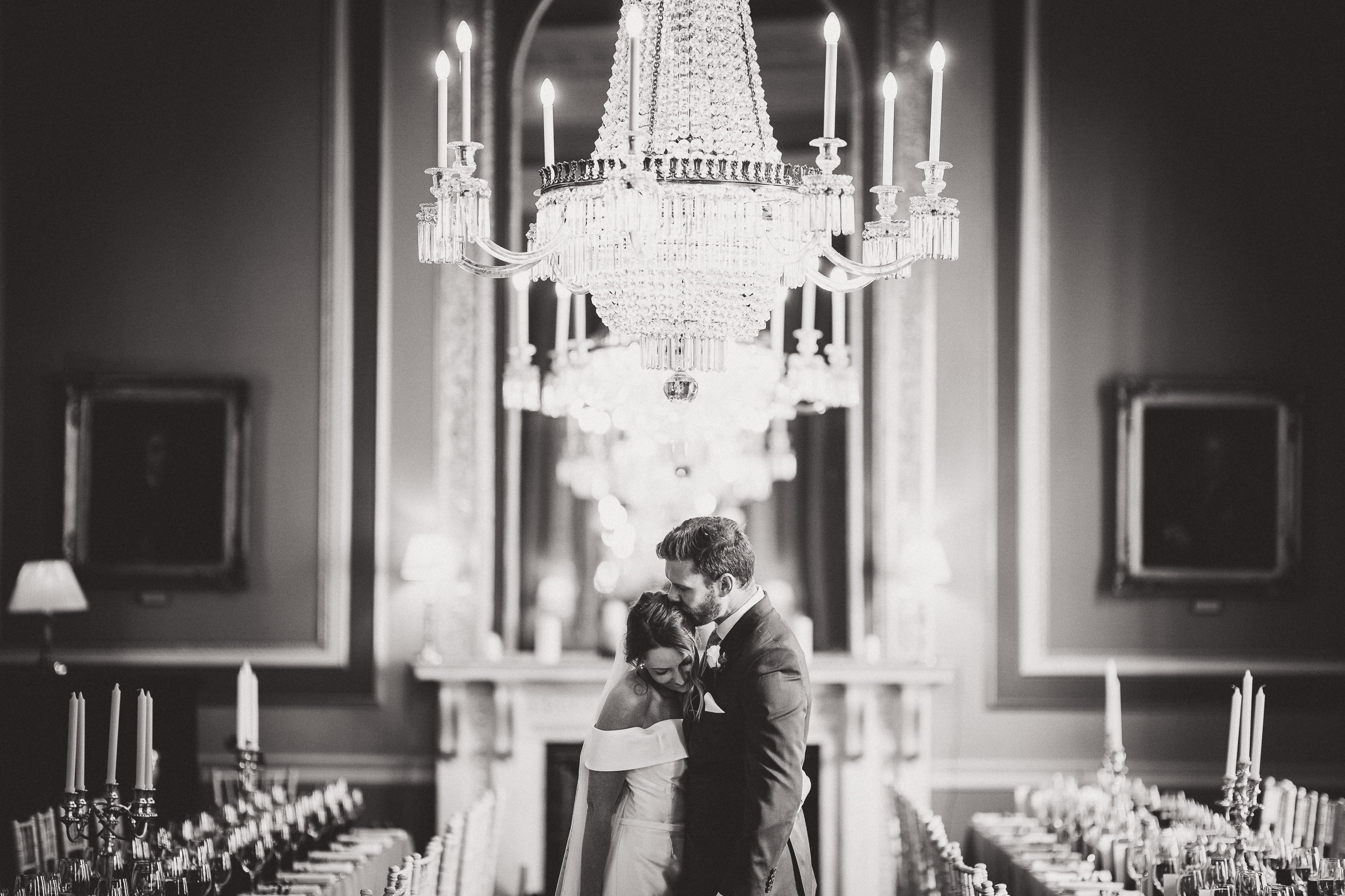 A bride and groom share a kiss captured by their wedding photographer.