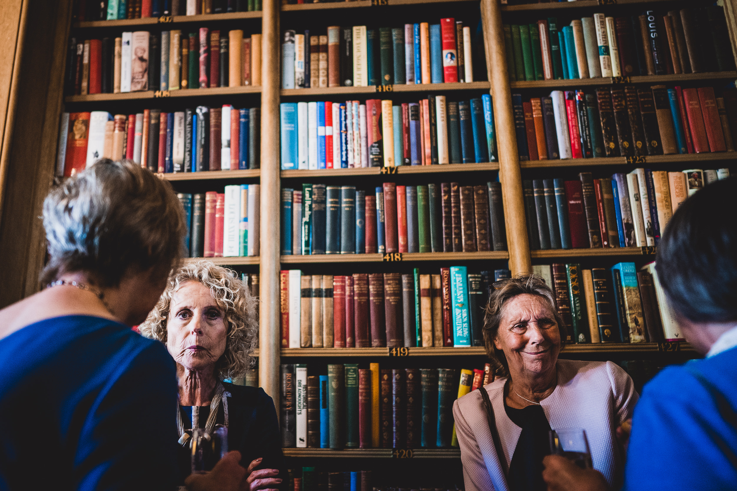 A group of bridesmaids posing in front of a bookcase.