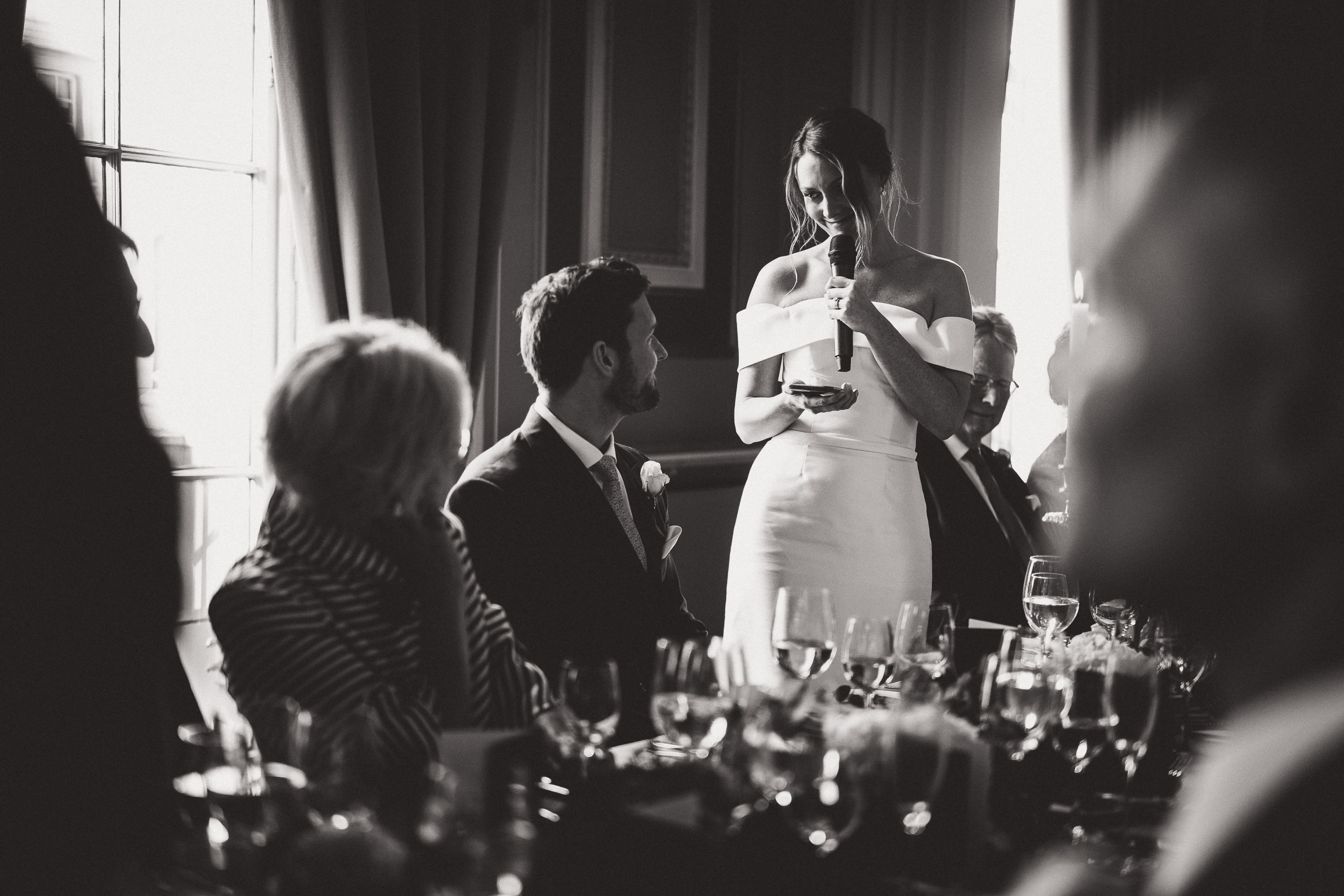 A bride giving a speech at her wedding, captured by the wedding photographer in a memorable wedding photo.
