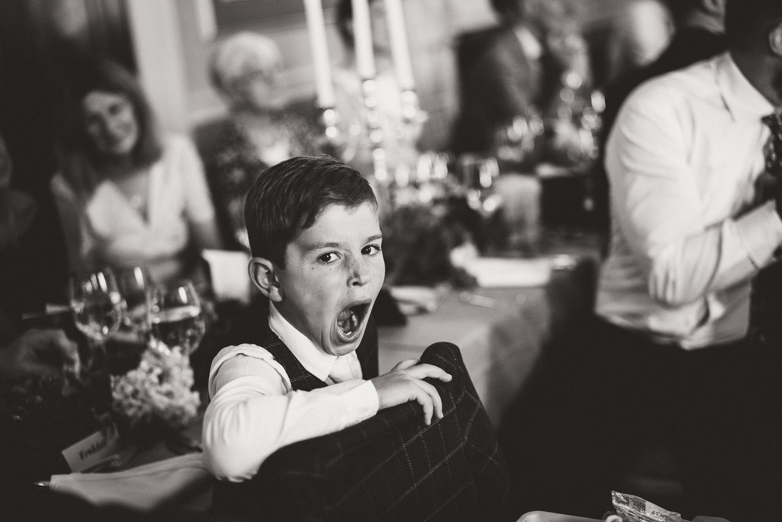A young boy disrupts a wedding reception with his loud yelling.