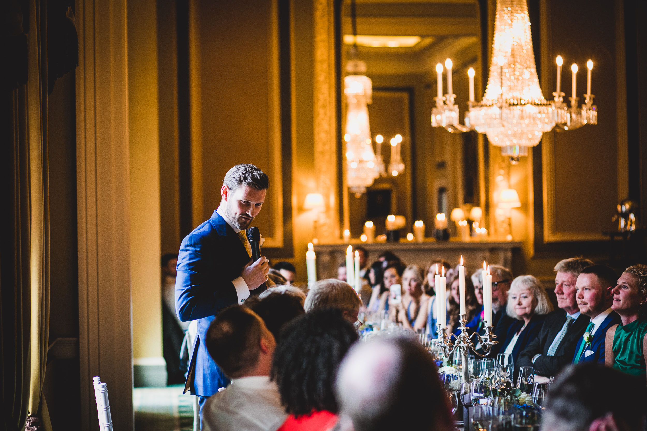 A groom giving a speech at a wedding reception.