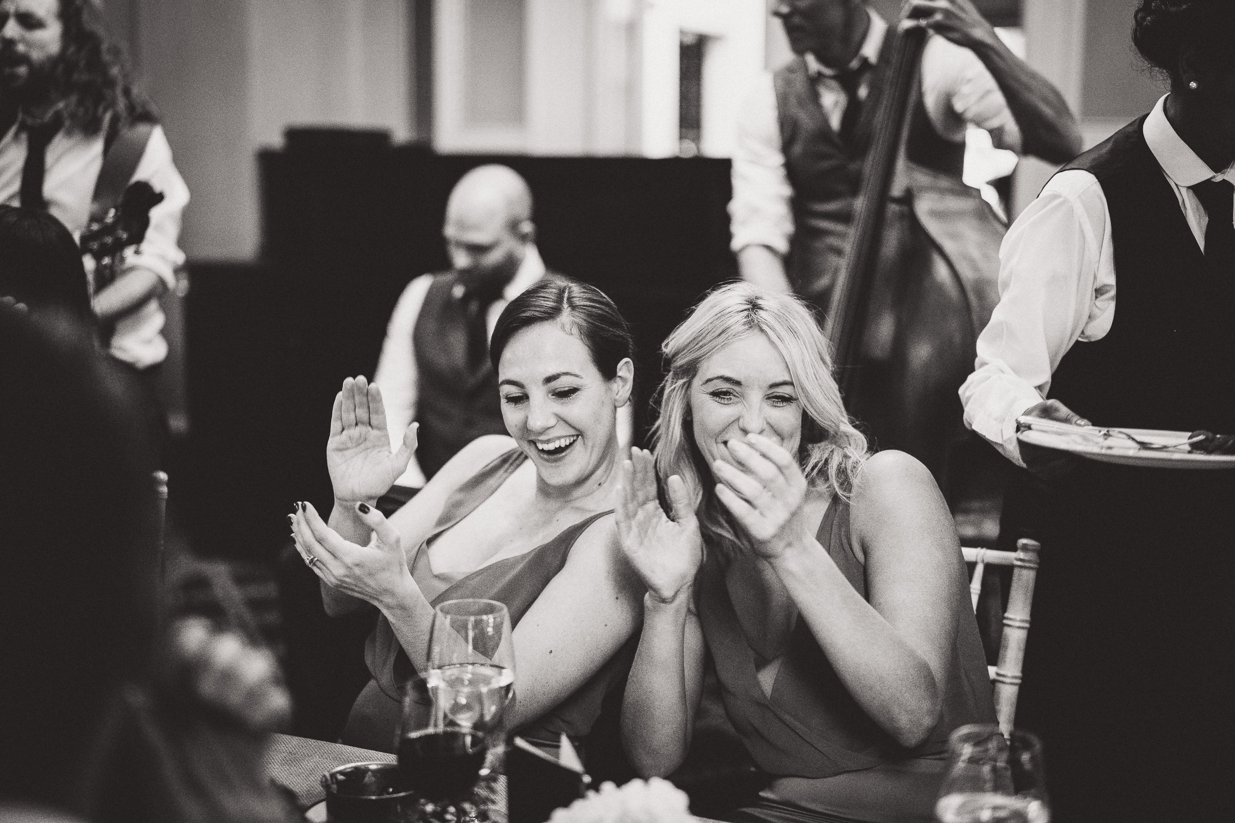 Bridesmaids clapping captured in a wedding photo by the wedding photographer.