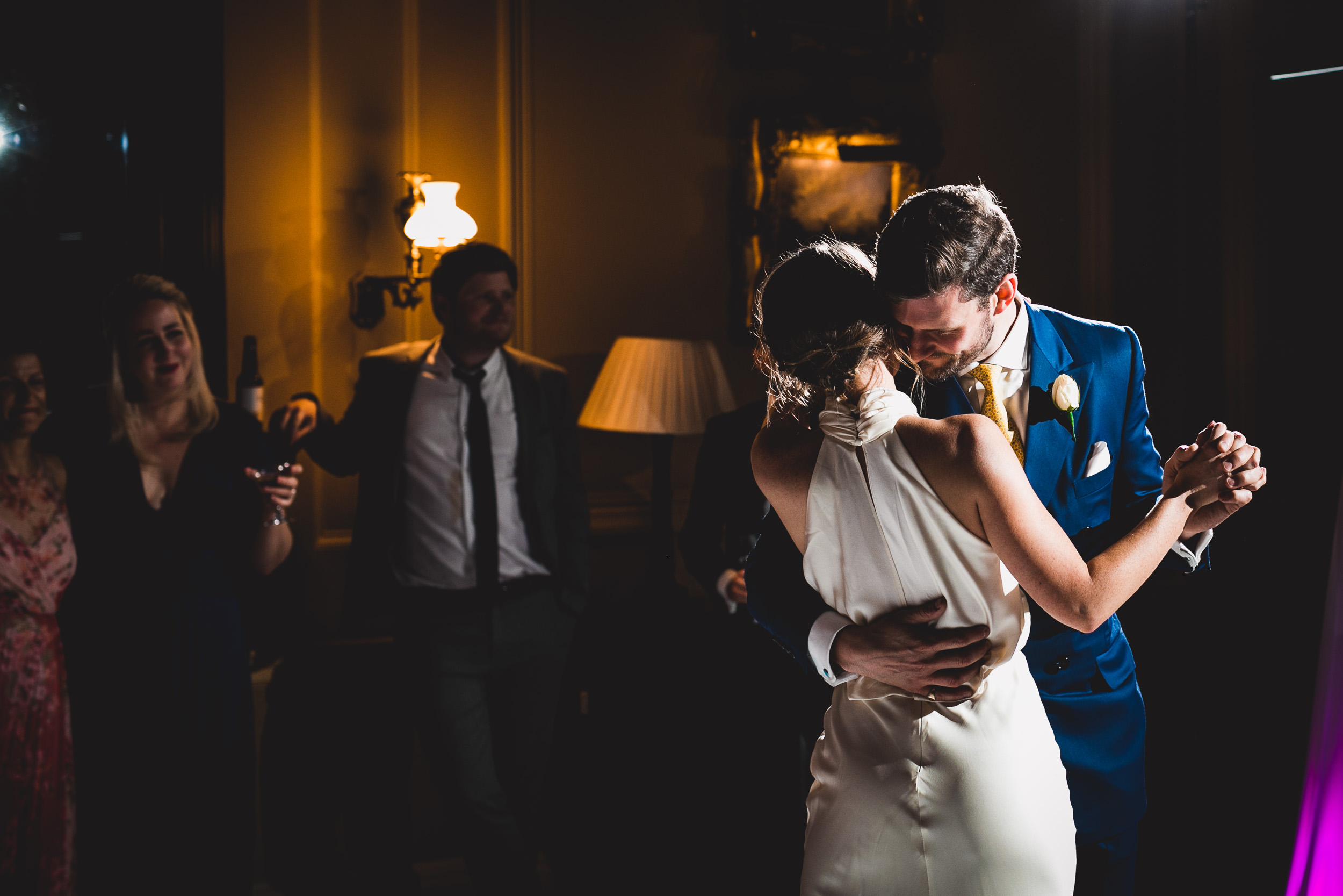 A bride and groom captured in a wedding photo, sharing their first dance.