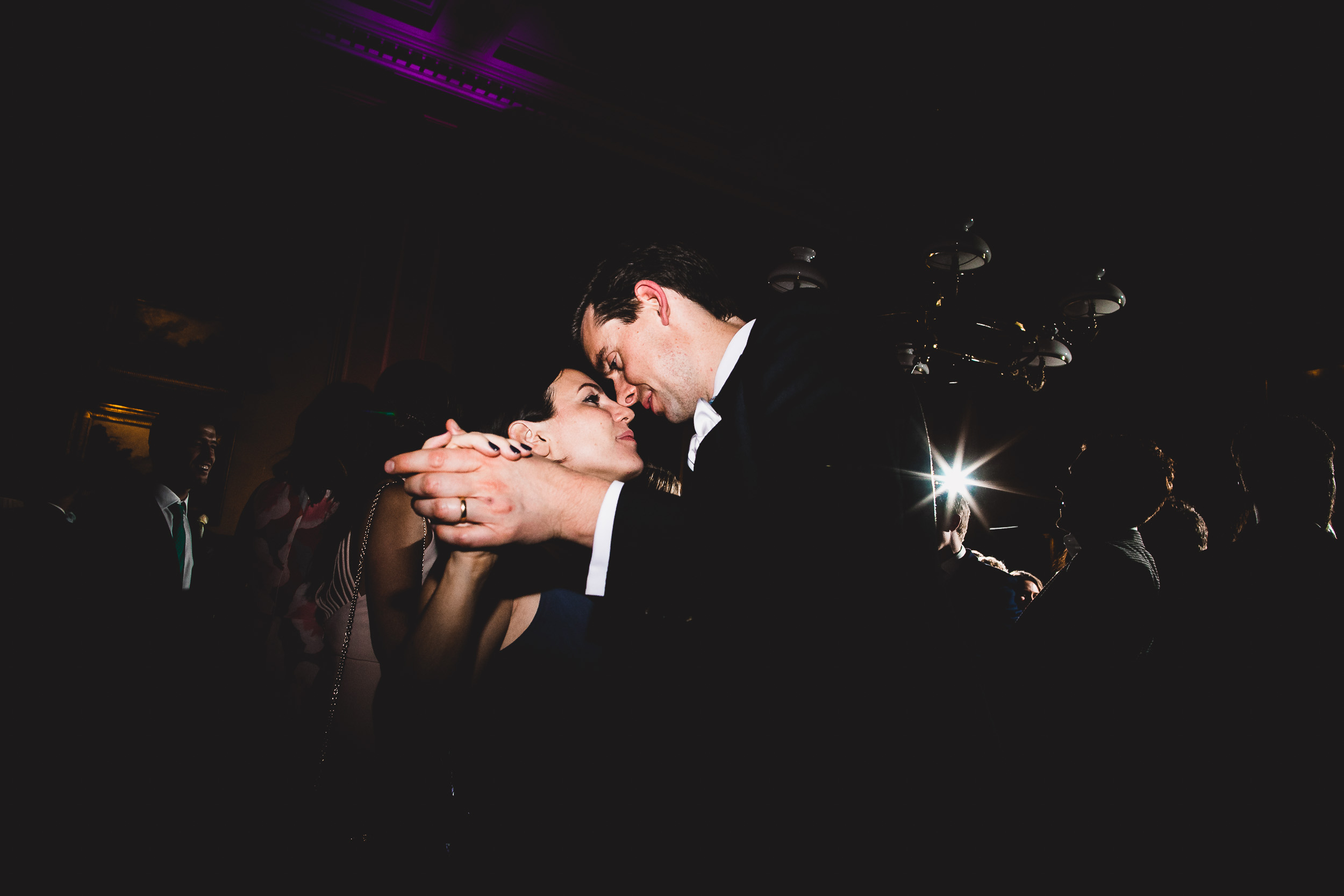 A bride and groom capturing a tender kiss in their wedding photo.