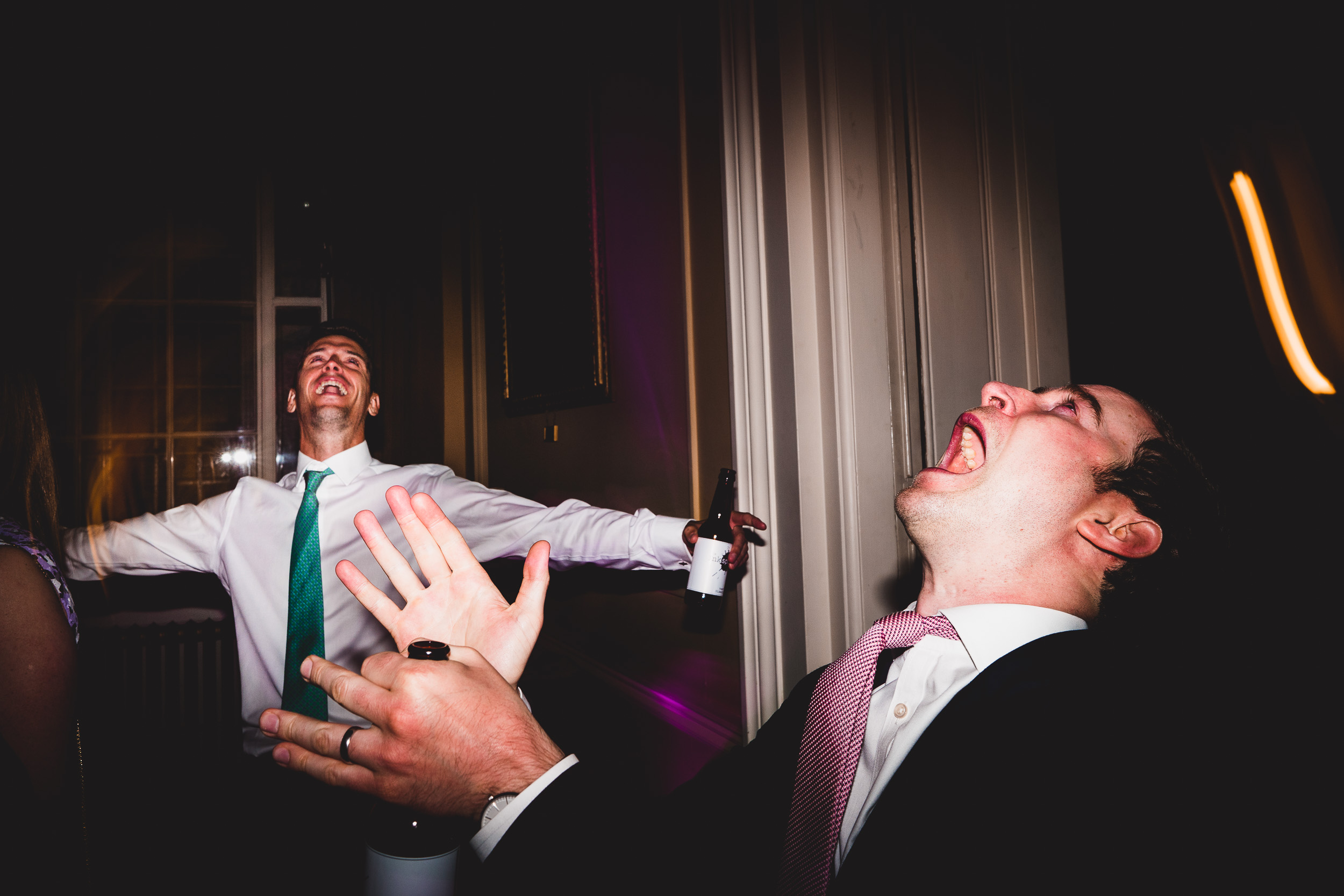 A groom in a suit is yelling at the bride in a wedding photo.