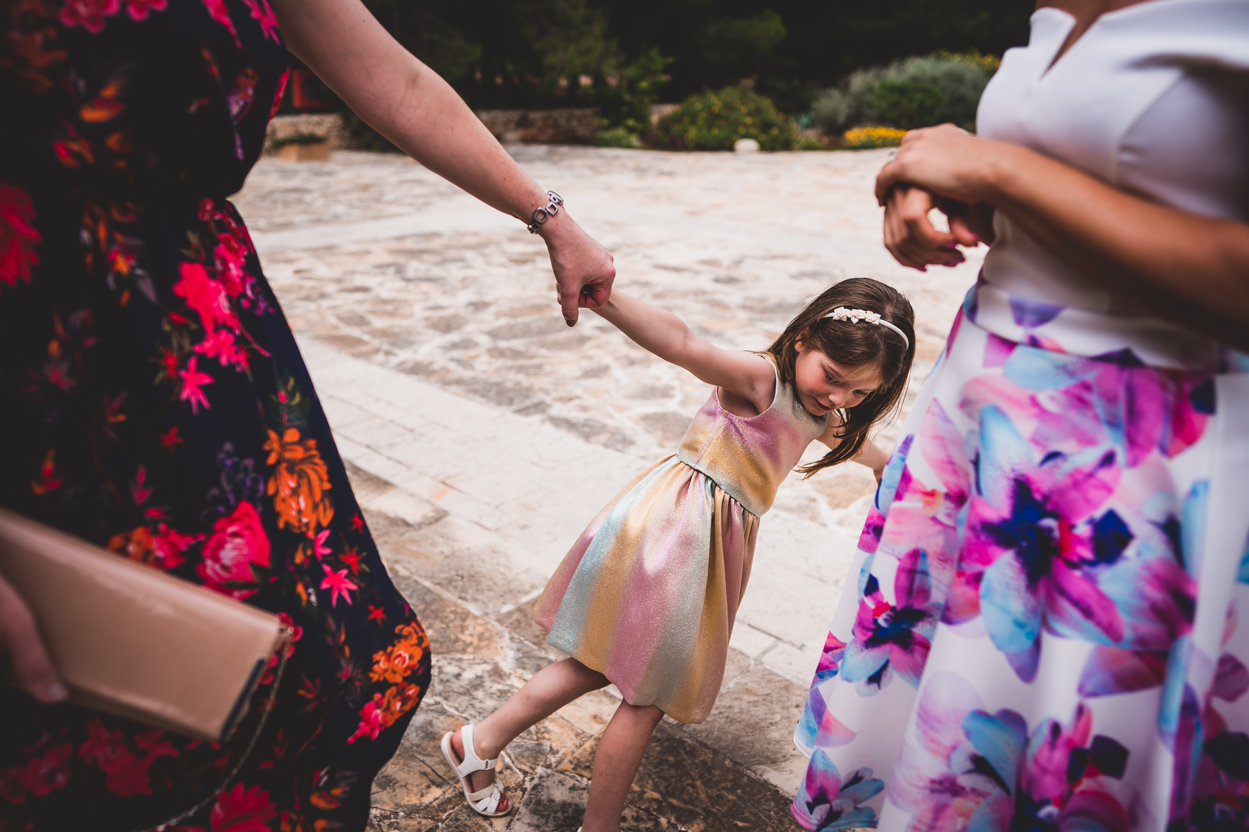 A little girl is holding the hand of a woman - wedding.