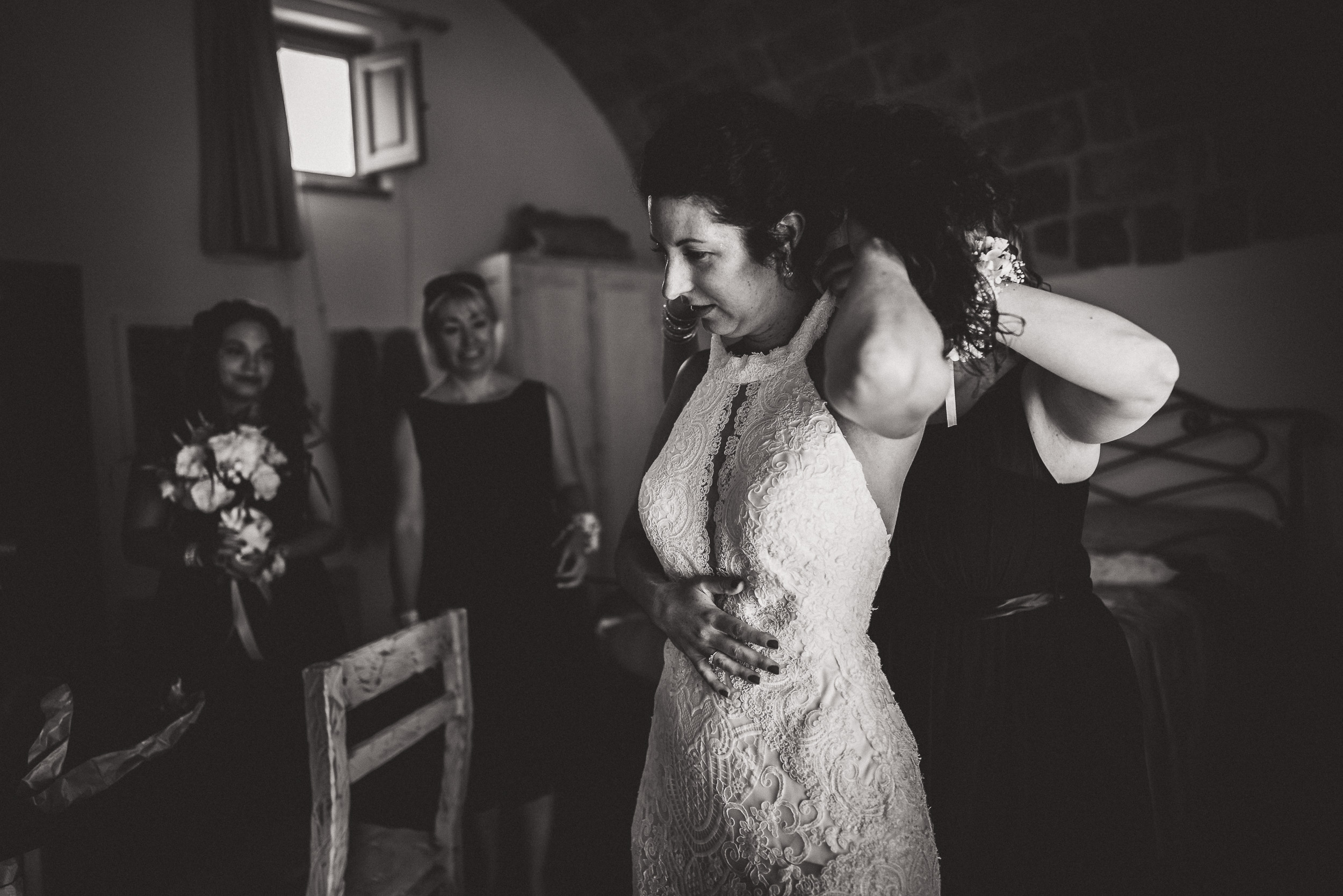 A bride getting ready for her wedding in Tuscany with a wedding photographer.