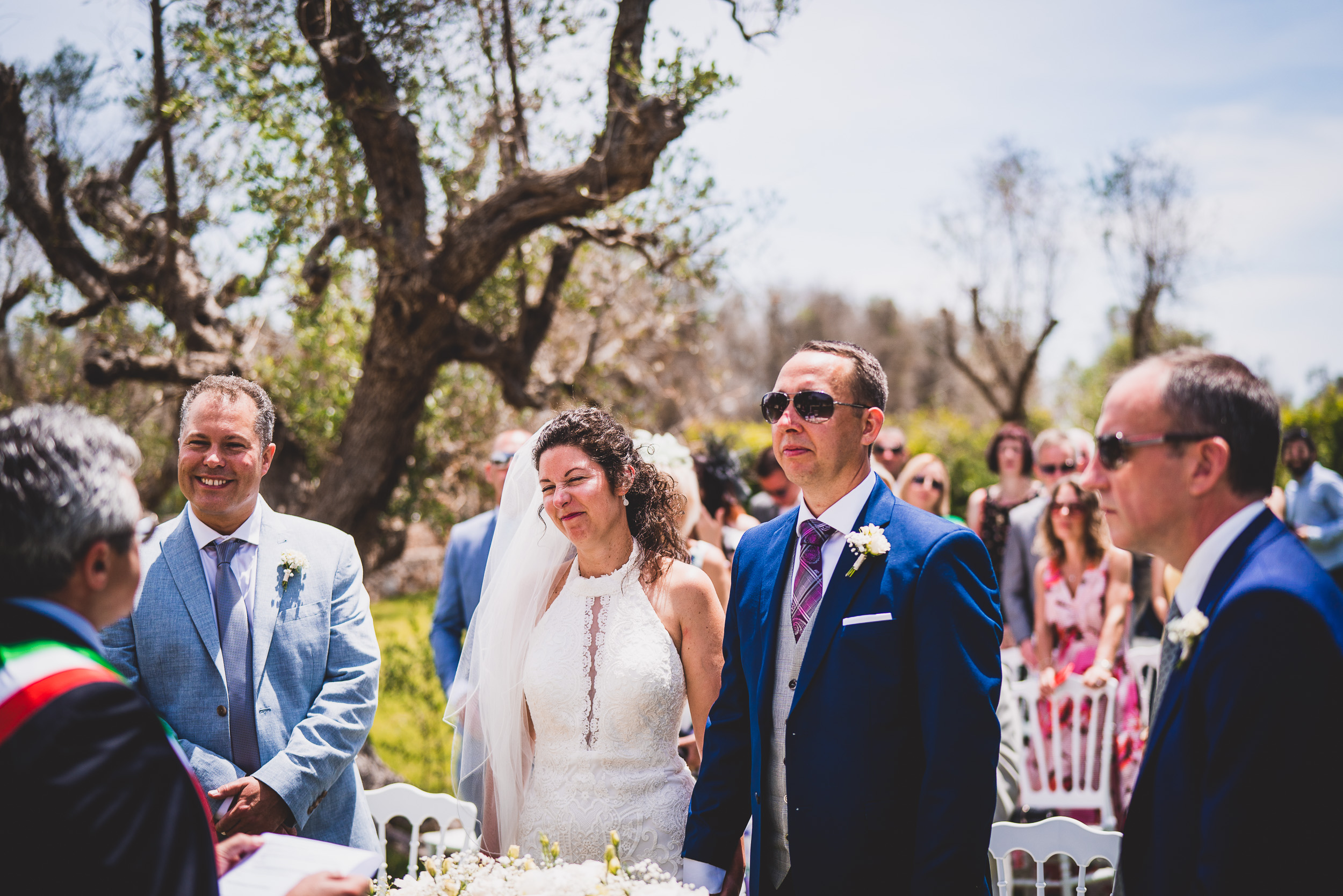 A groom looks at the bride during their wedding ceremony.