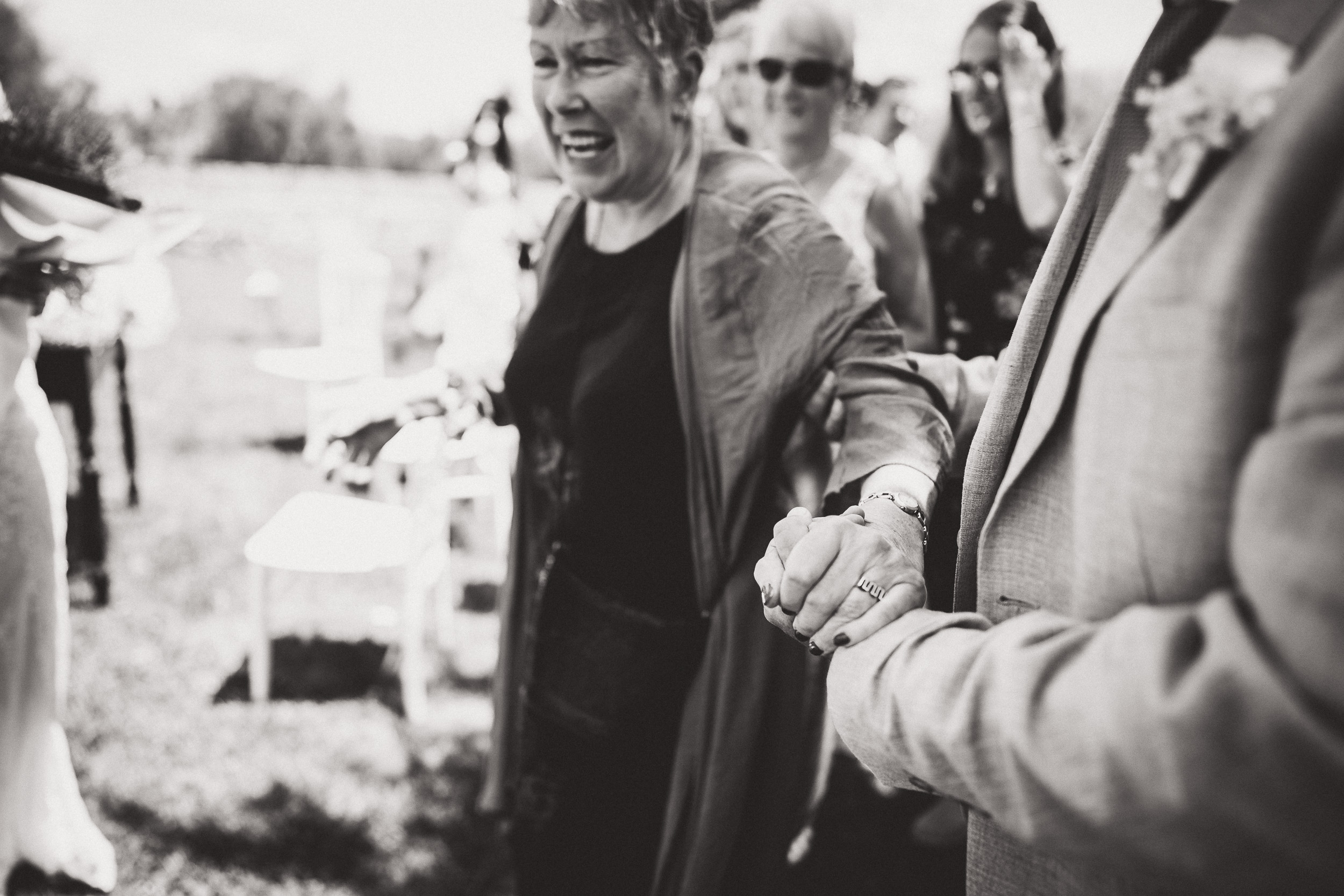 A bride and wedding photographer walking down the aisle at a wedding.