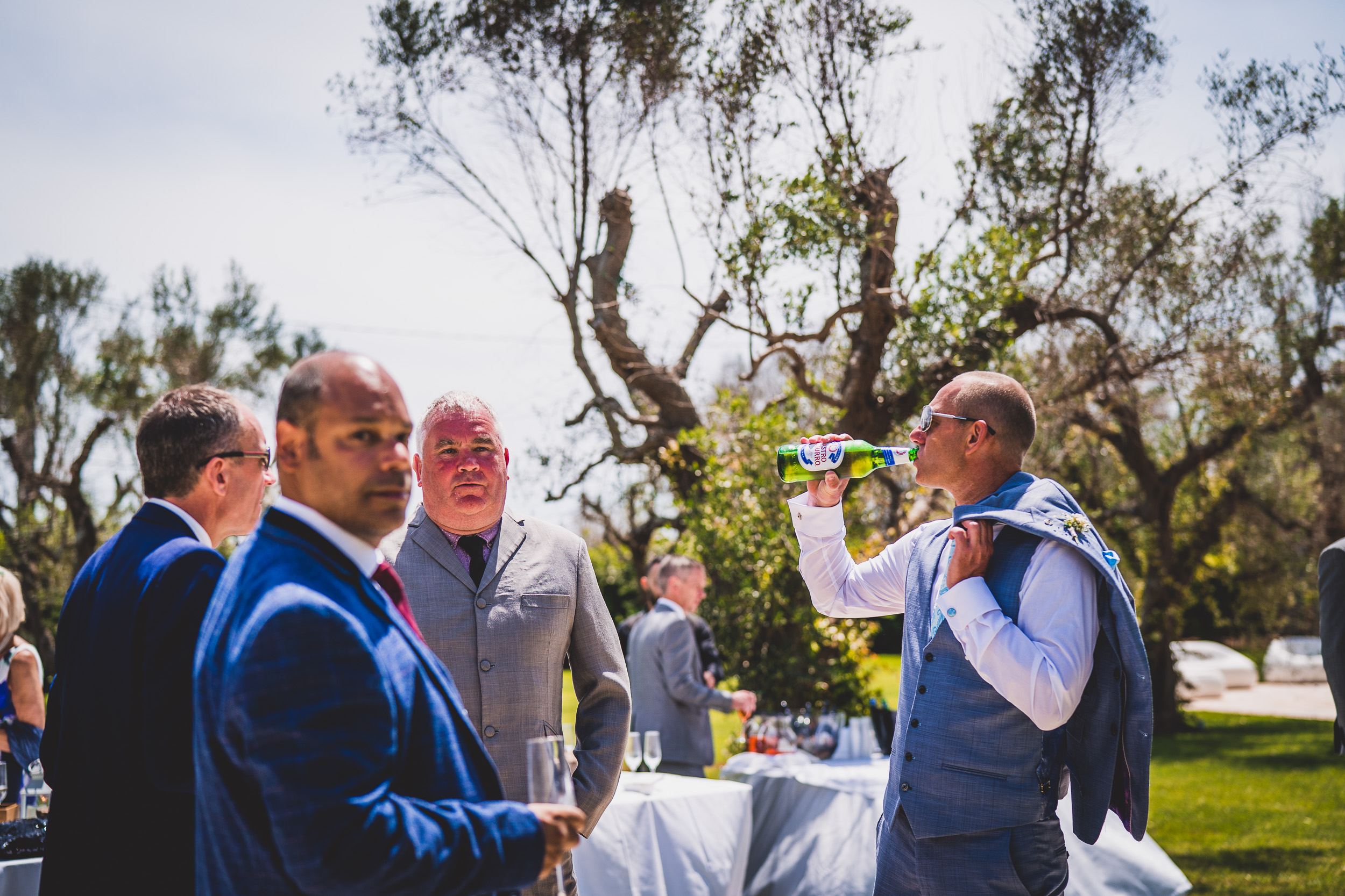 A group of men celebrating at an outdoor wedding.