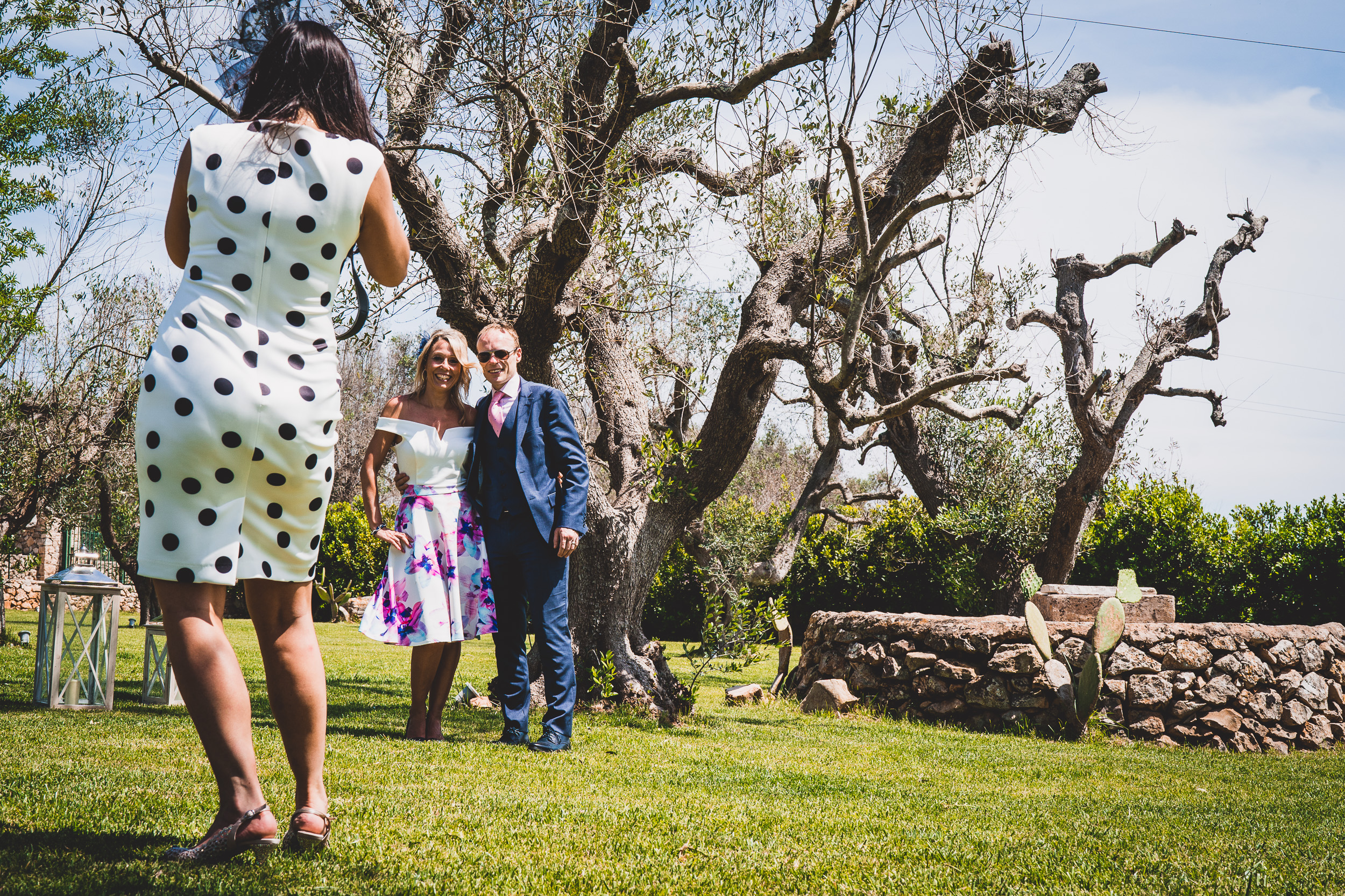 A couple, bride and groom, capturing each other's moments with the assistance of a wedding photographer.