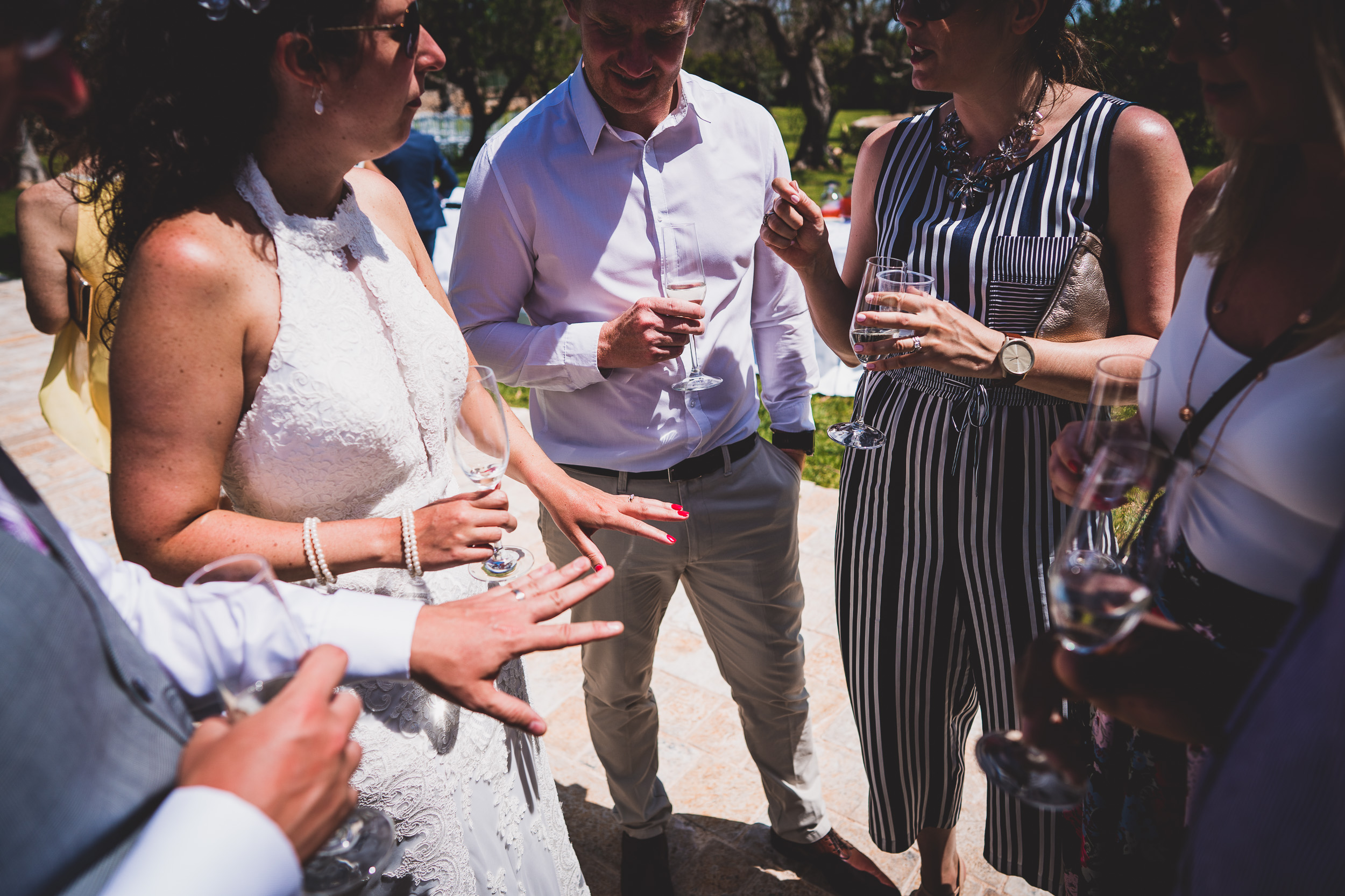 A group of people conversing at a wedding reception.