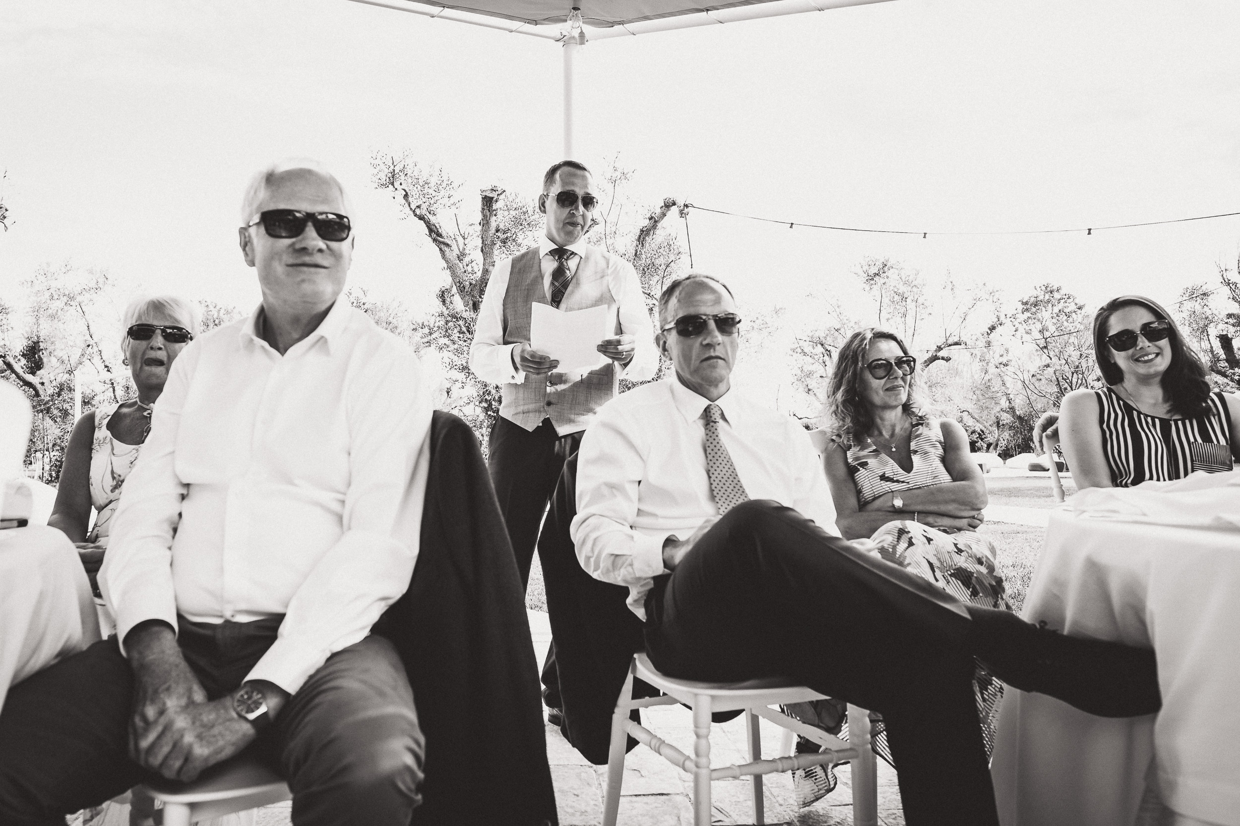 A black and white wedding photo capturing a group of people.