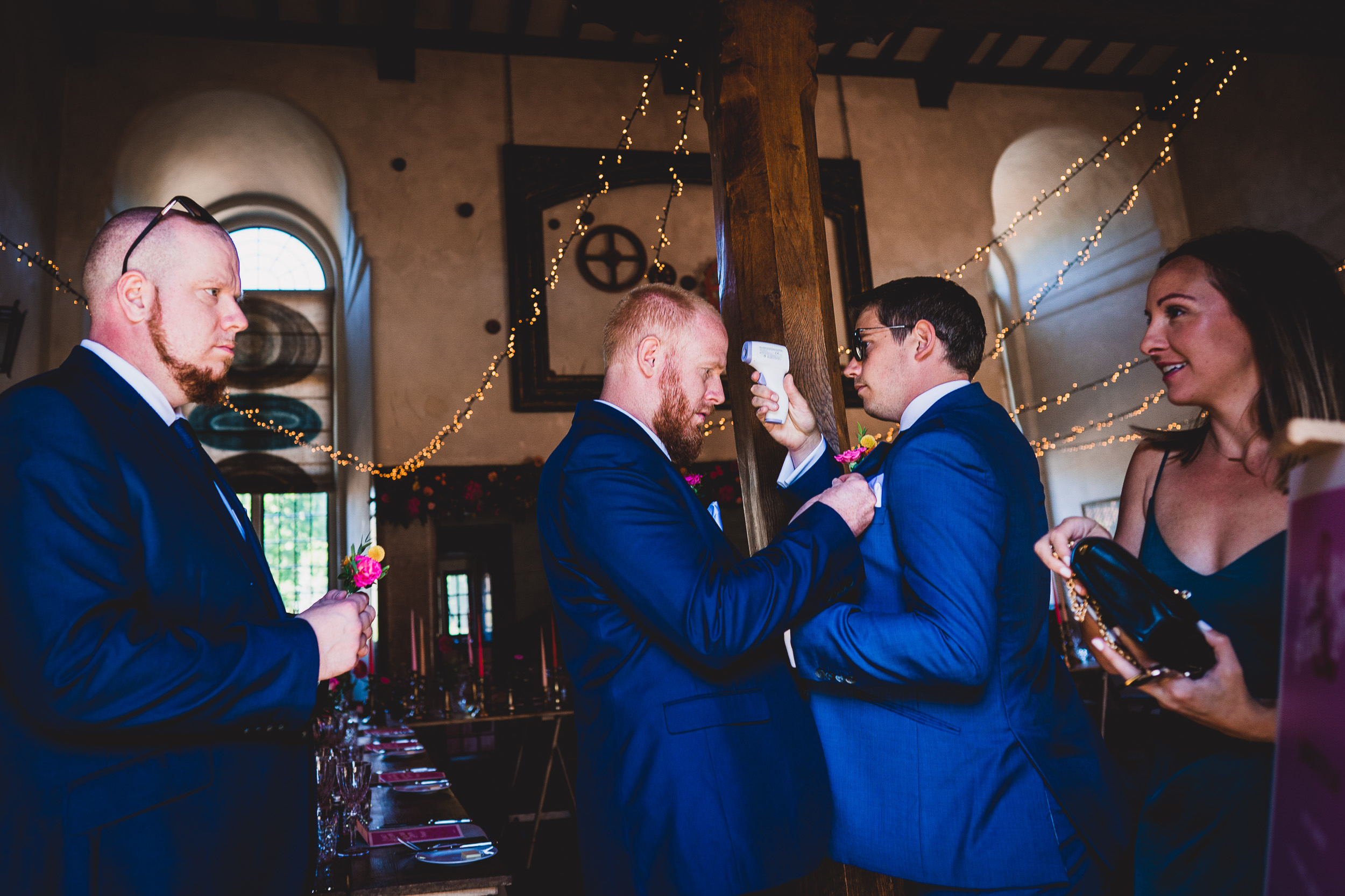 A group of men are preparing for a wedding photo.