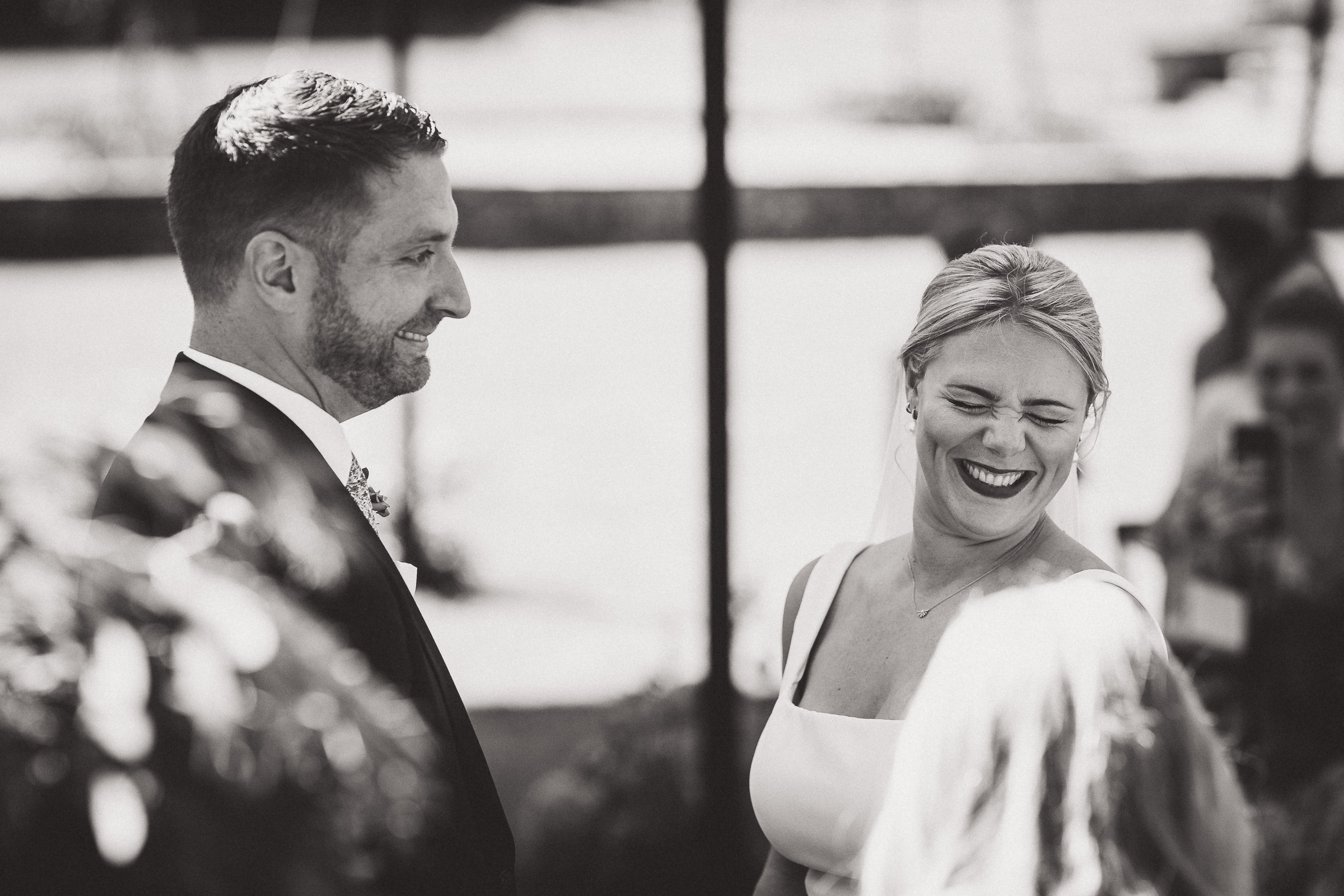 A wedding photographer captures the joyful moments of a bride and groom during their ceremony.