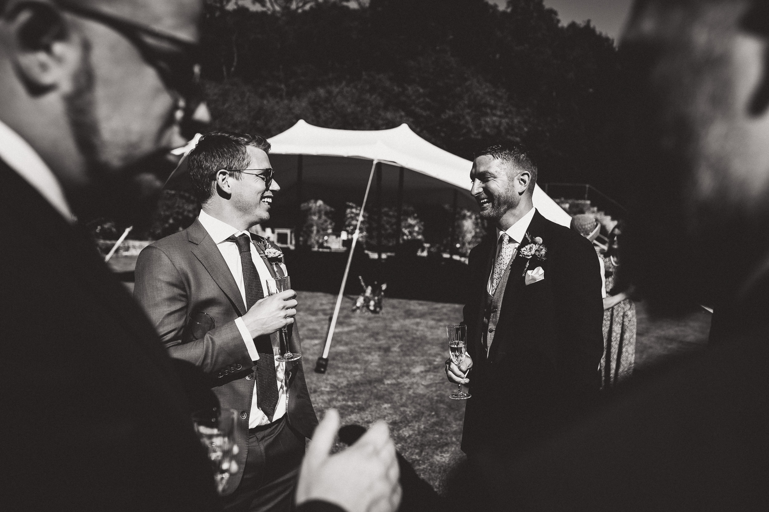 A photo of two men chatting in a tent.