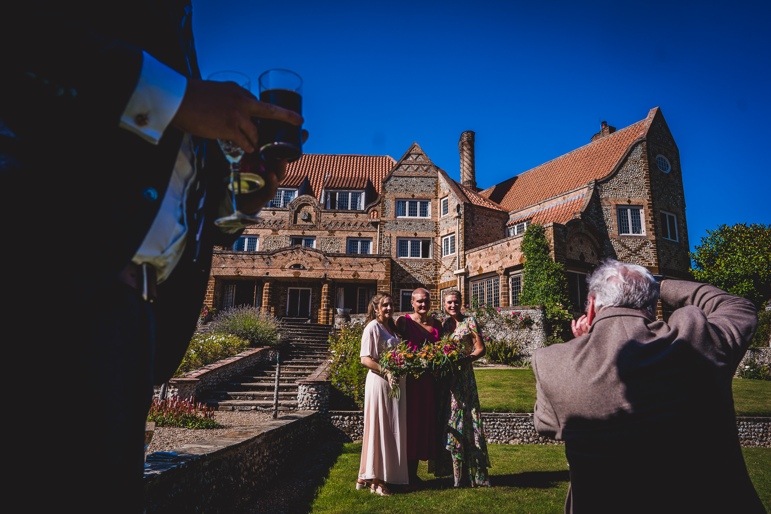 A wedding couple posing for a photo at a picturesque mansion.