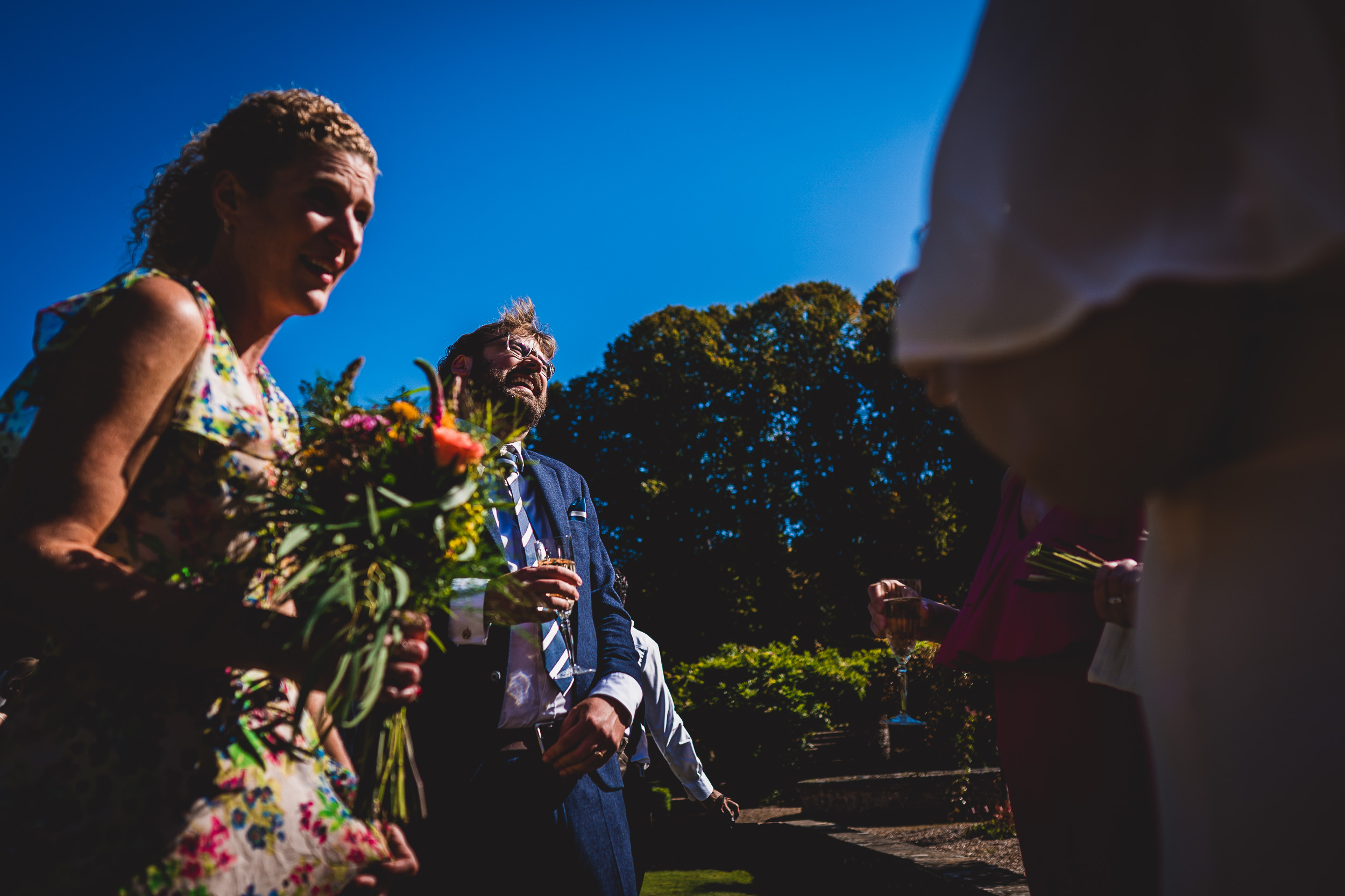 A wedding photographer captures a heartfelt moment between a bride and groom during the ceremony.