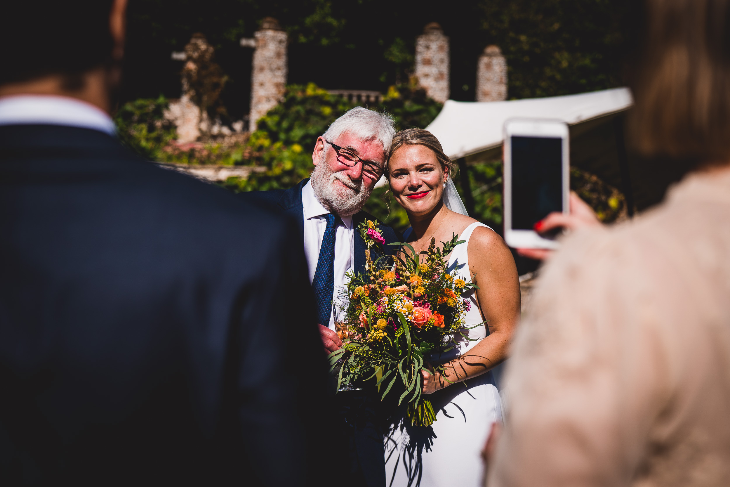 A wedding couple capturing photos during their ceremony.