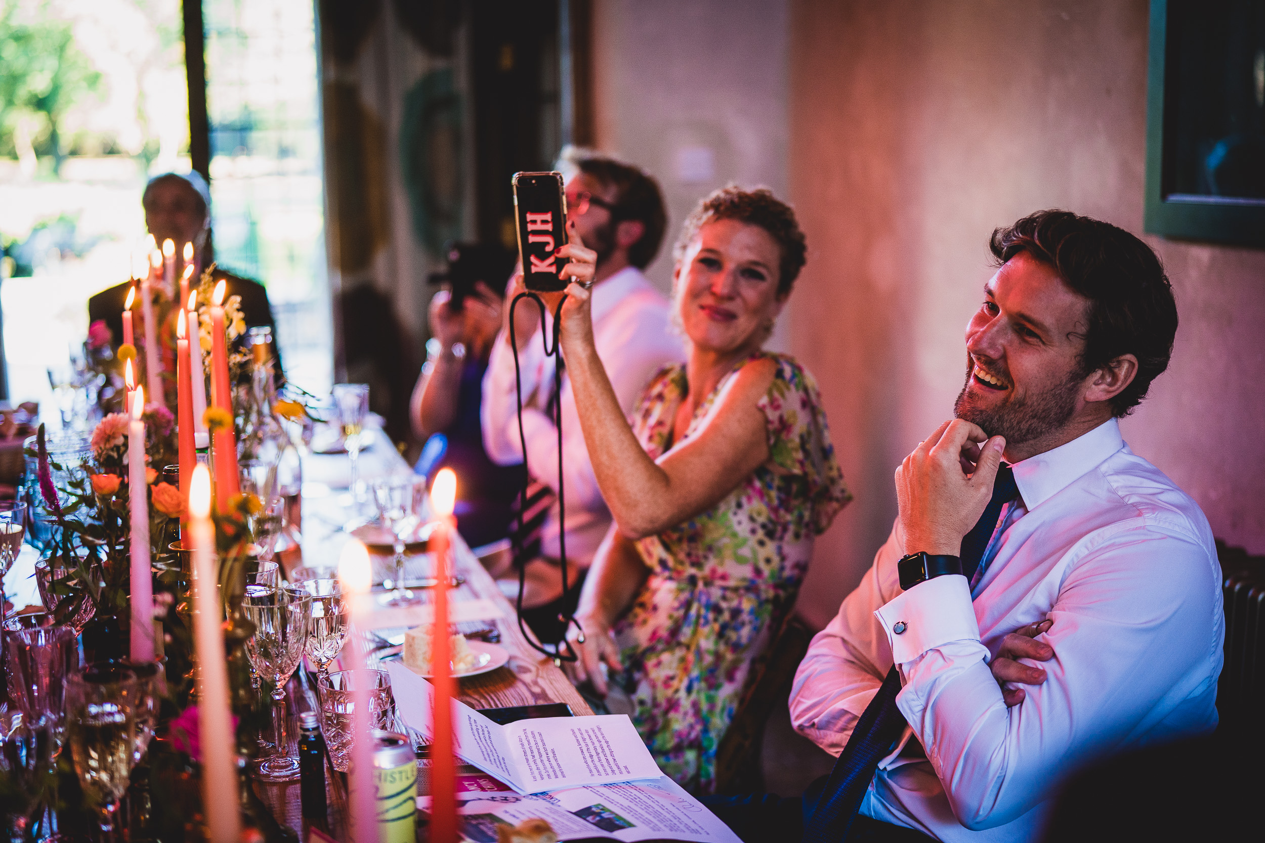 A couple takes a wedding selfie at their reception.