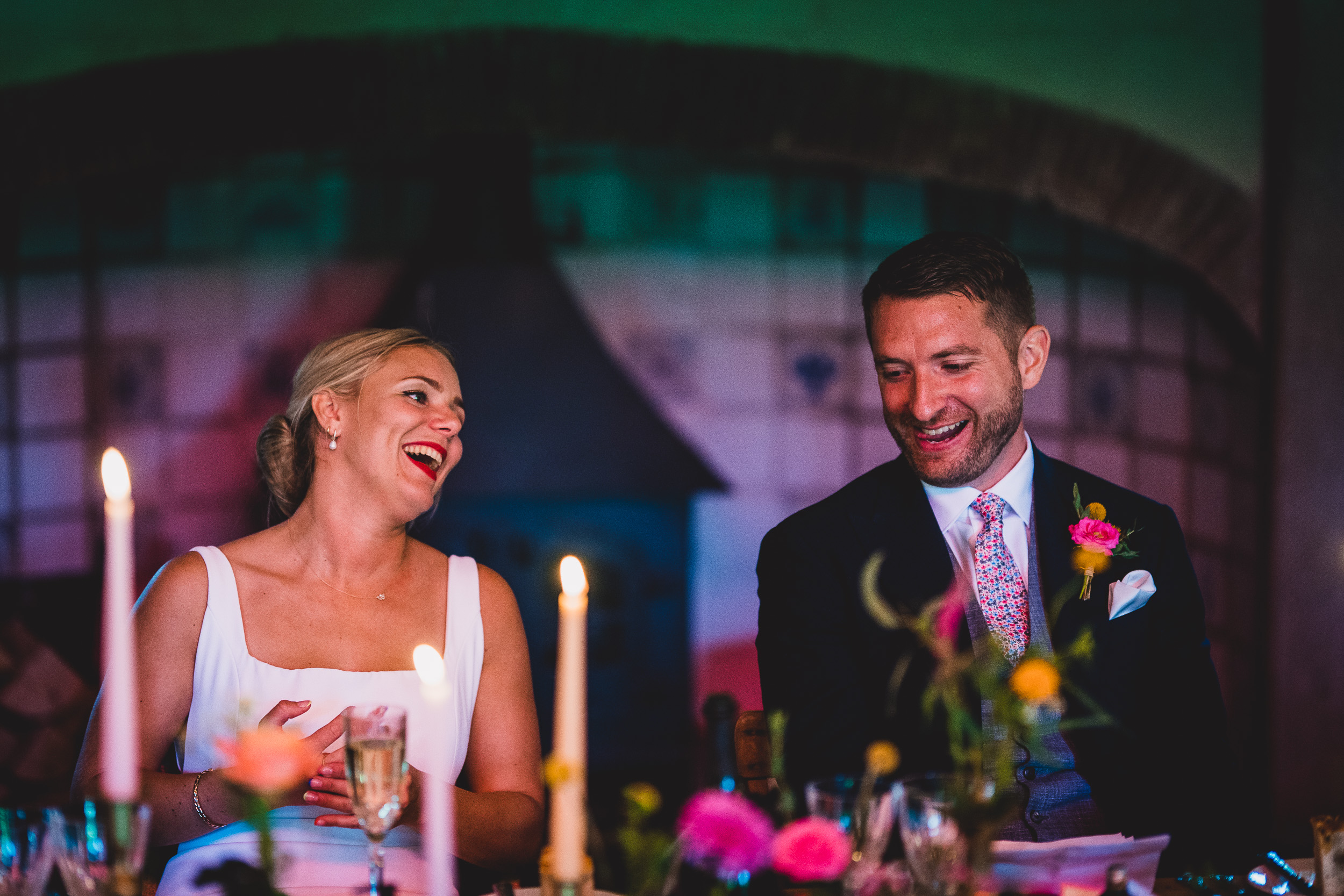 A bride and groom captured joyfully by the wedding photographer.