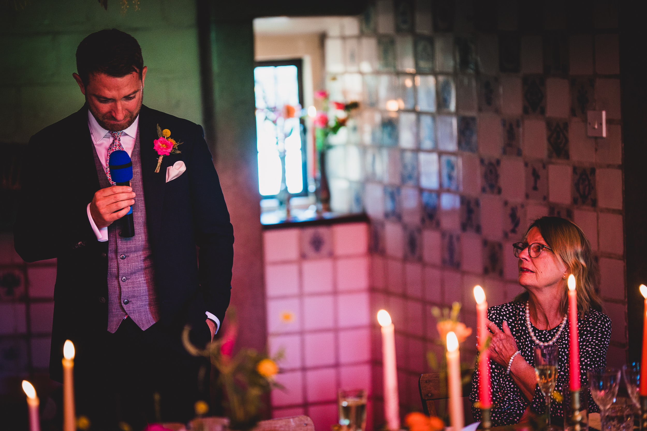 A man is giving a speech at a wedding.