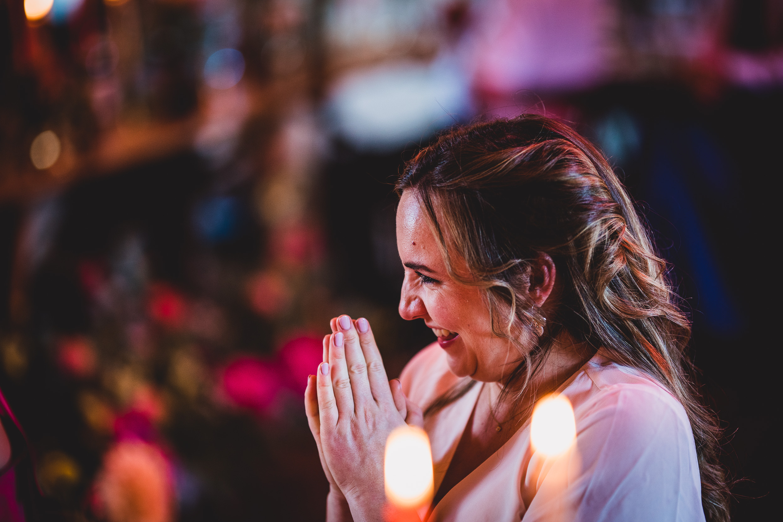 A bride applauding at her wedding, captured by a wedding photographer.