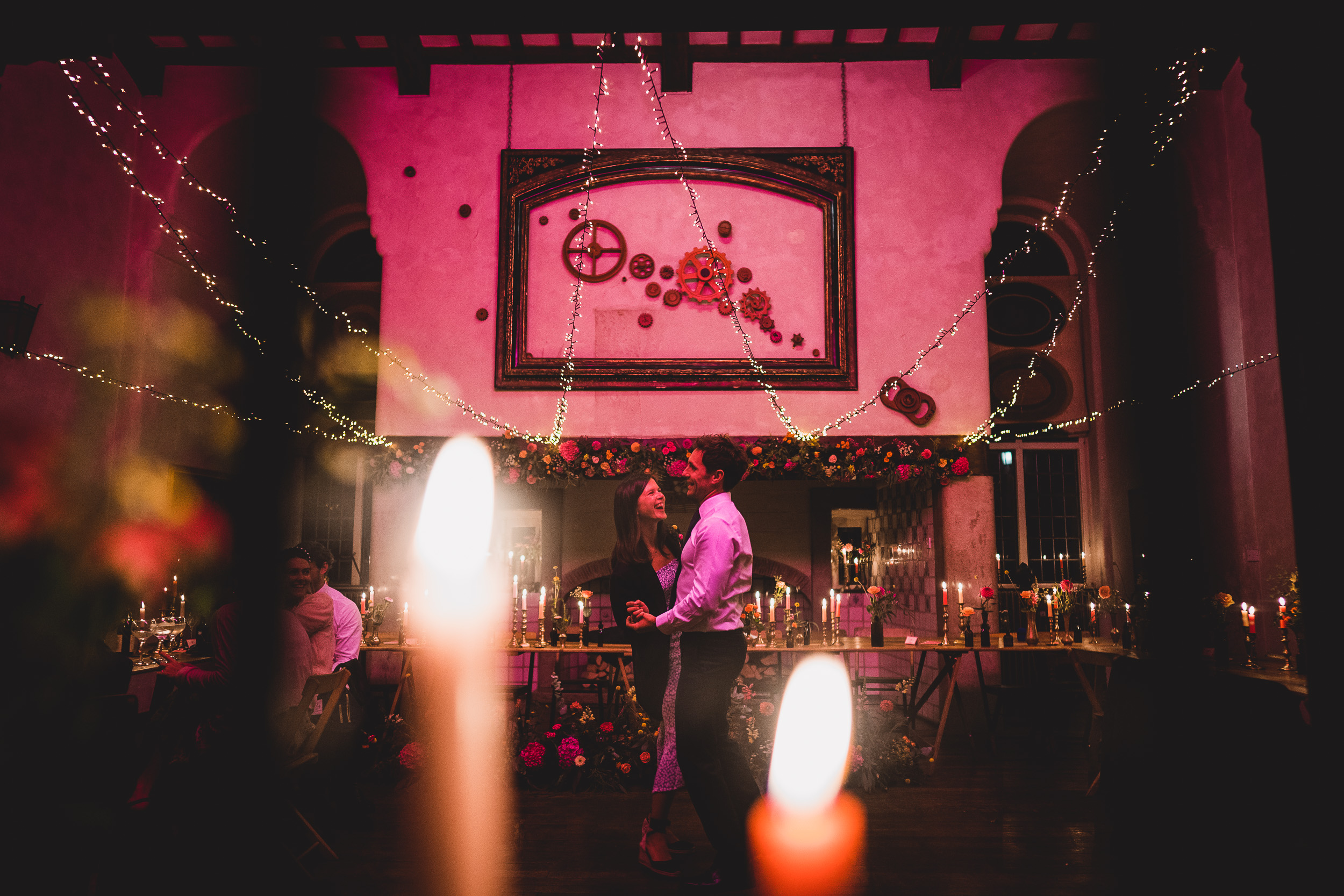 A bride and groom captured in a wedding photo surrounded by candles.